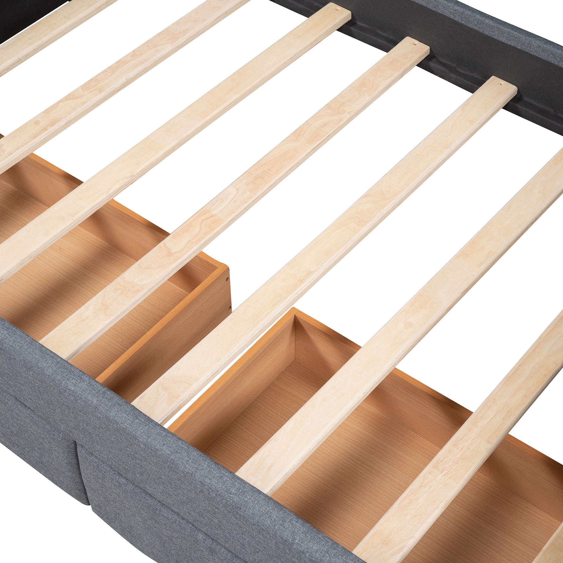 Gray upholstered bed frame showing wooden slats and underbed storage drawers
