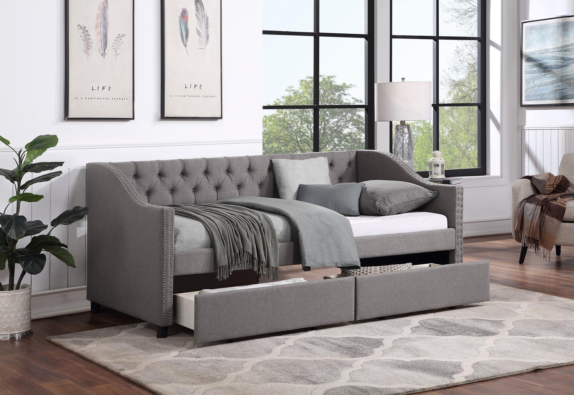 Tufted gray fabric daybed with storage drawers and nailhead trim
