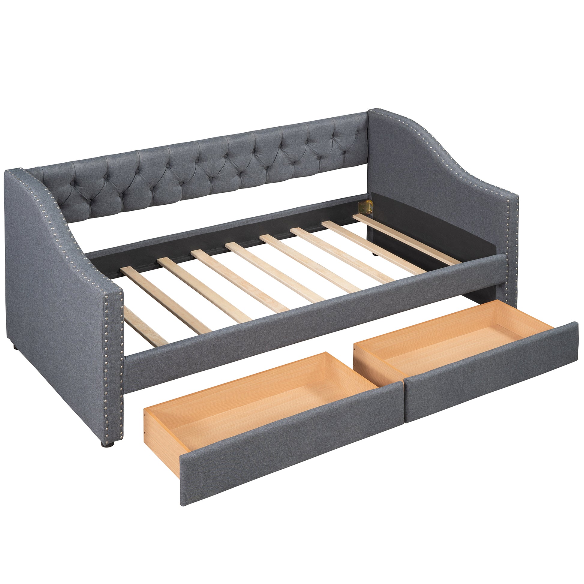 Dark grey tufted daybed with ornate nailhead trim and two pullout storage drawers