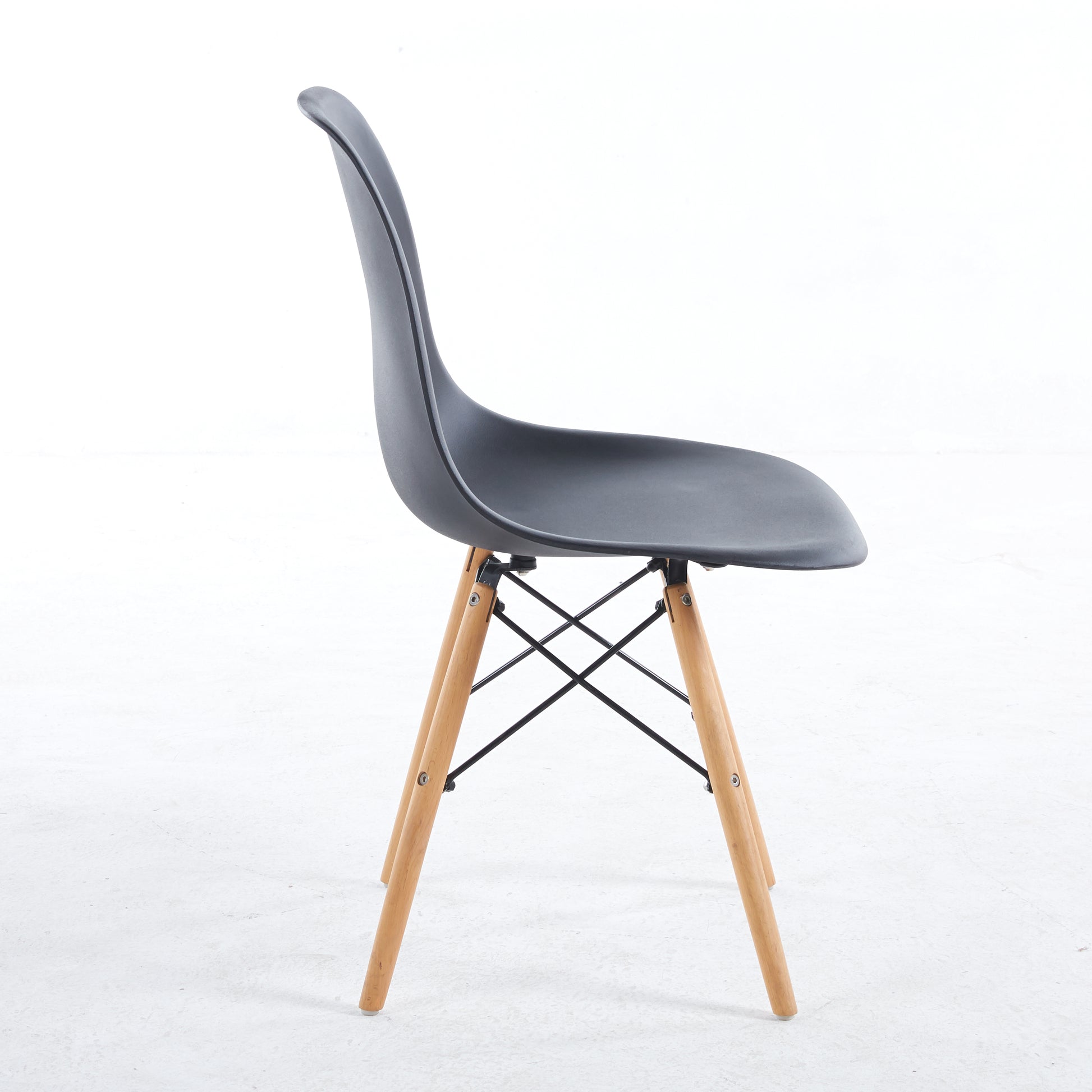 Black molded plastic chair with natural wood legs and cross brace