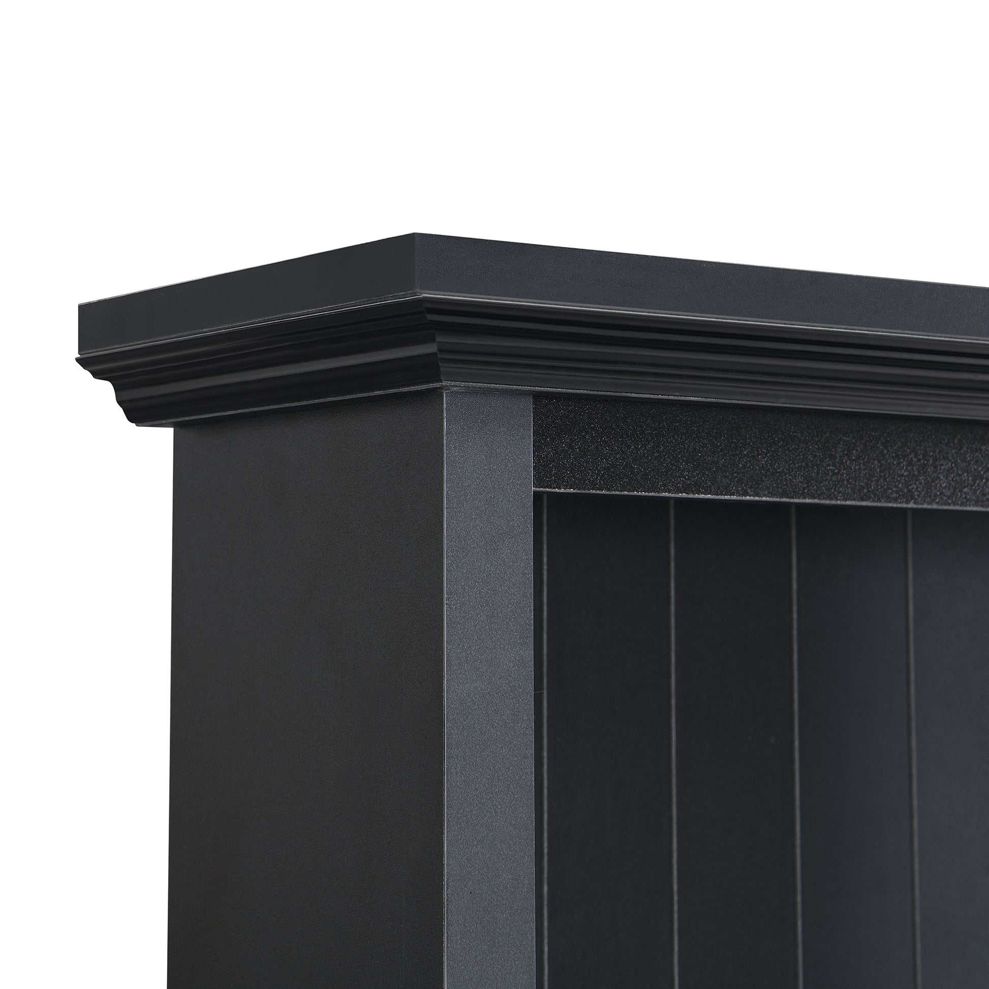 Detailed view of the ornate black cornice on a dark wood bookshelf
