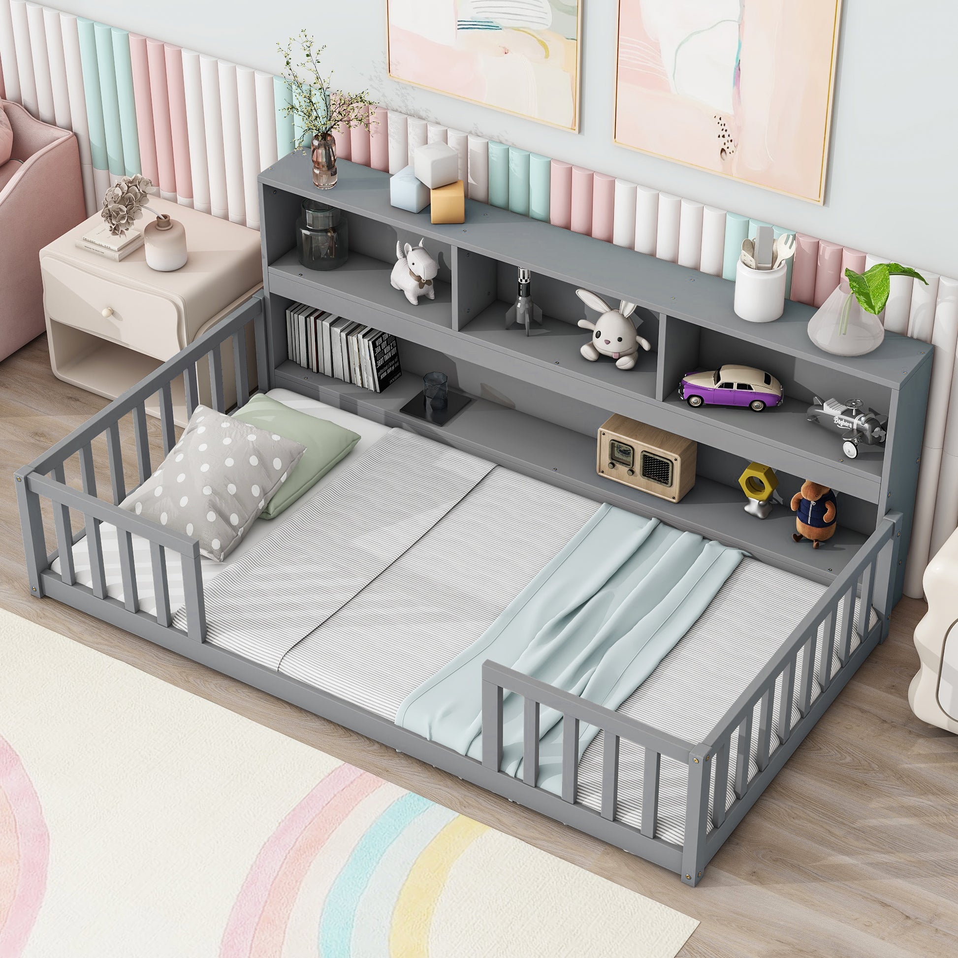 Grey toddler bed with safety rails and integrated shelving unit