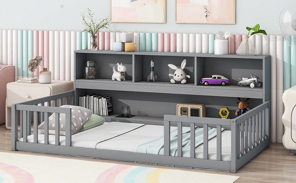 Gray wooden toddler bed with integrated bookshelf and safety rails