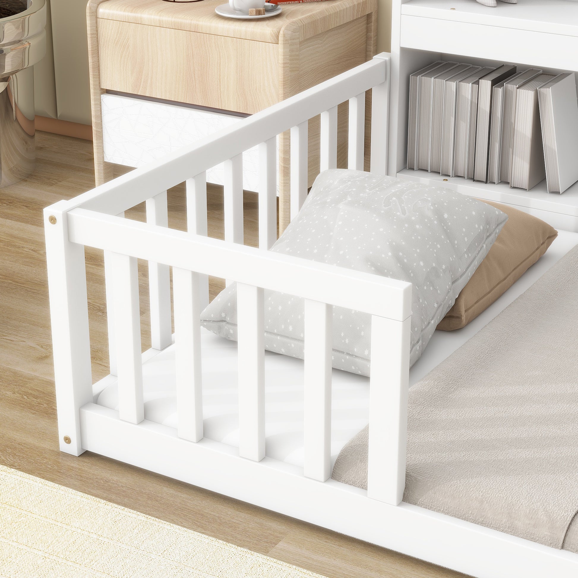 White wooden toddler bed with starry patterned pillows and beige blanket