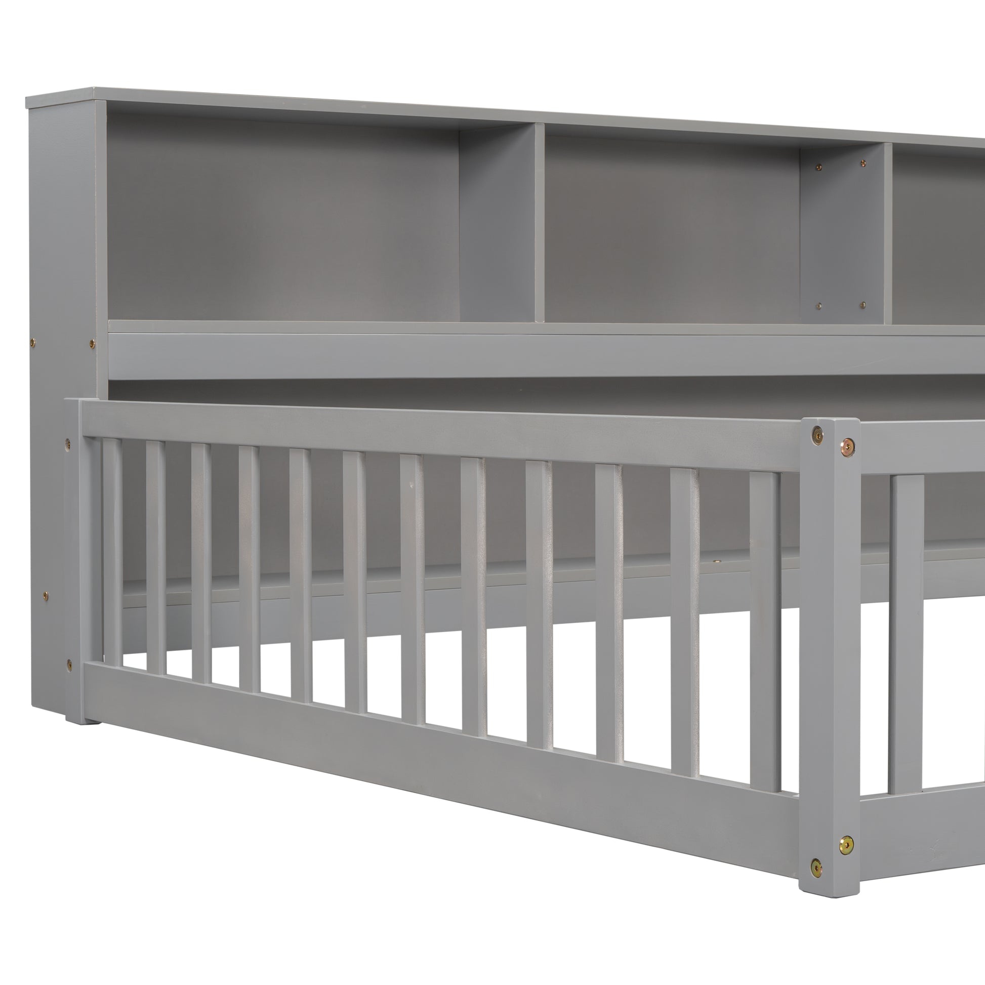 Gray wooden toddler bed frame with attached bookshelf headboard and safety rails