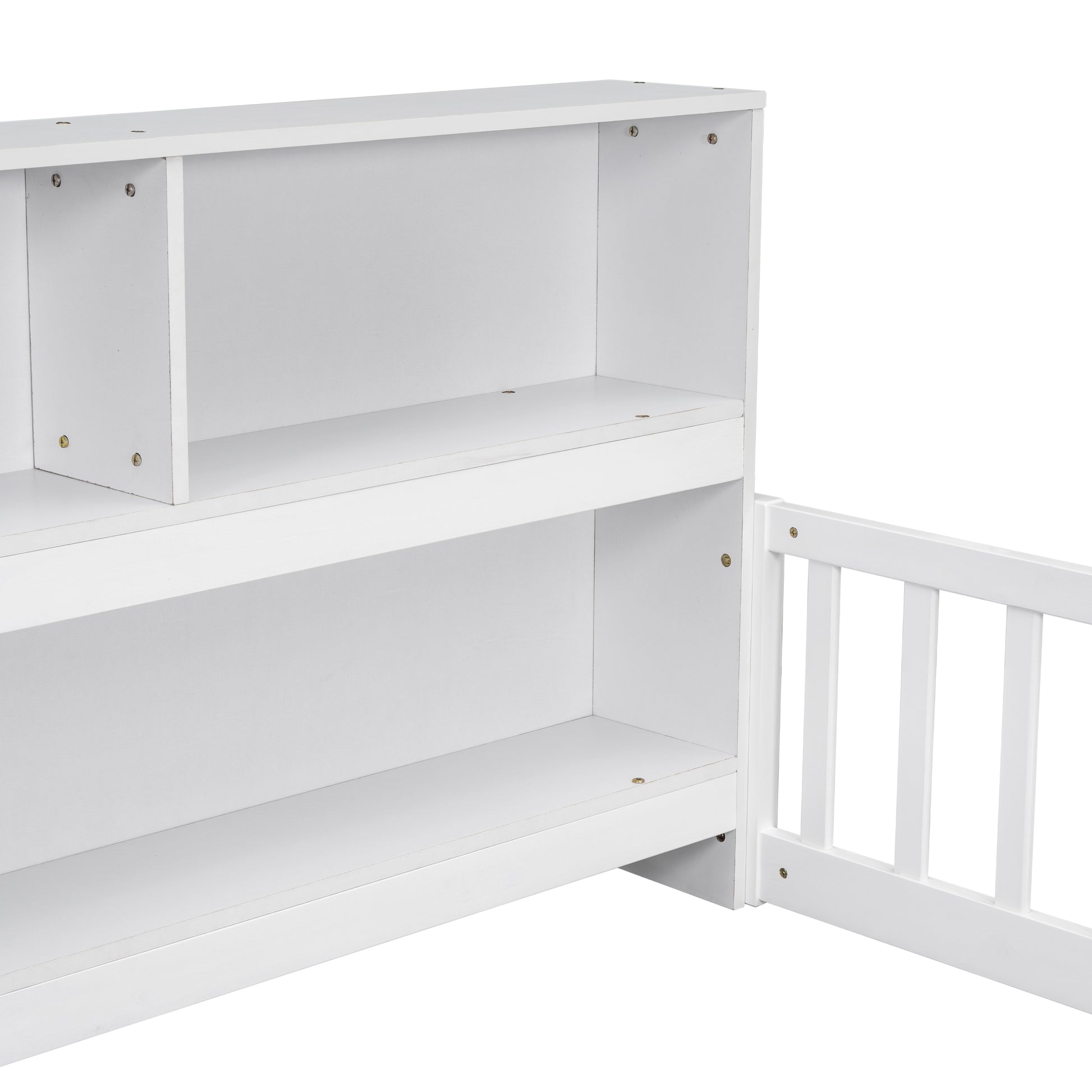 White wooden bookshelf with open shelves and partial view of a criblike side rail