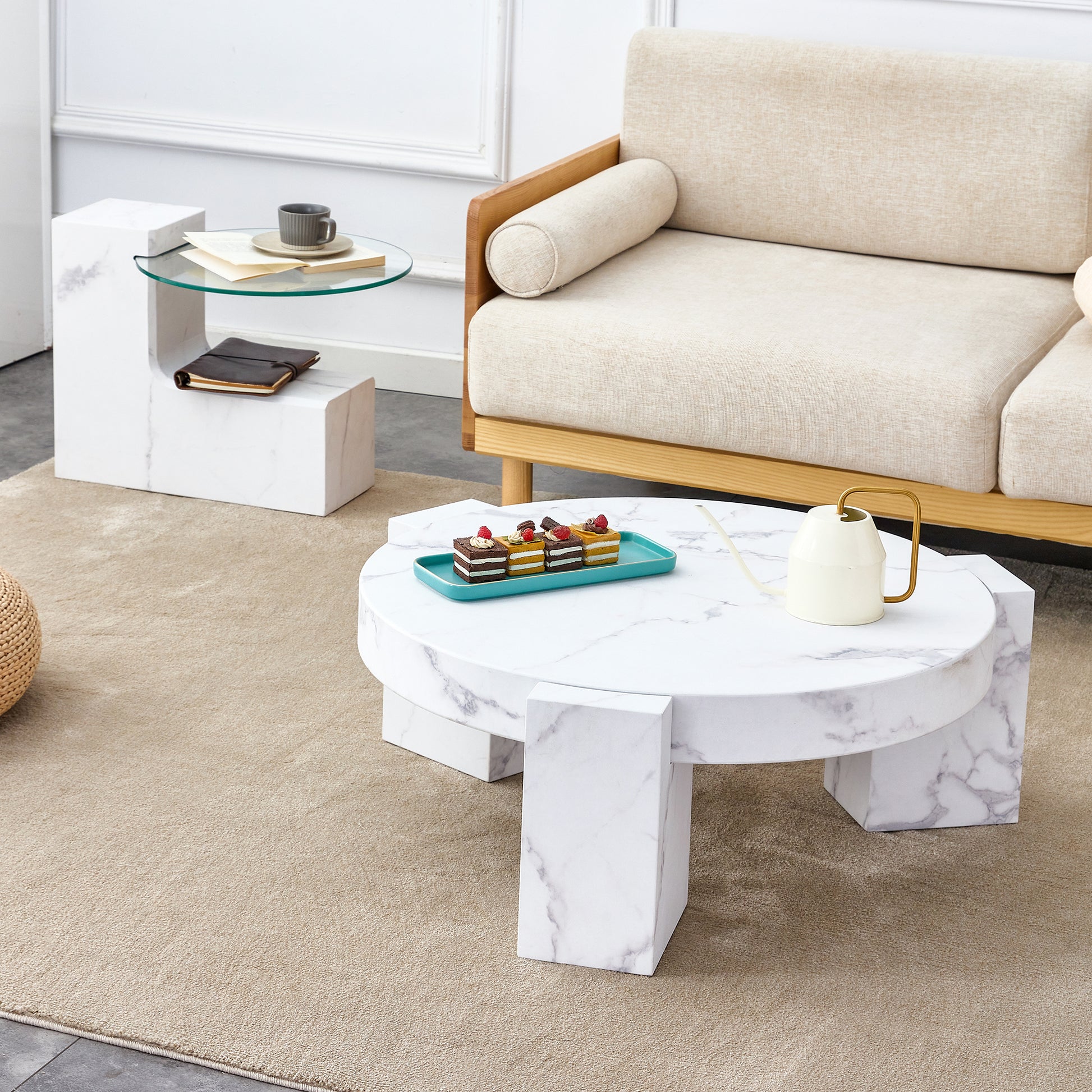 Modern marble coffee table with geometric legs and assorted pastries on a turquoise platter