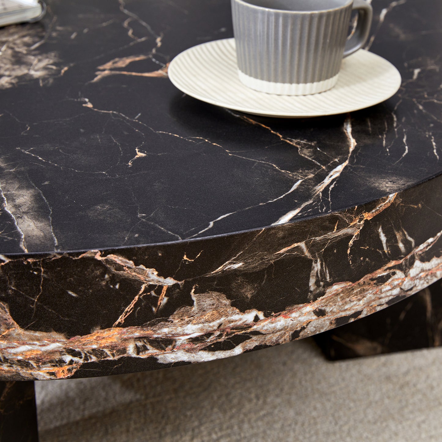 Dark marble coffee table with gold veining perfect for modern living rooms