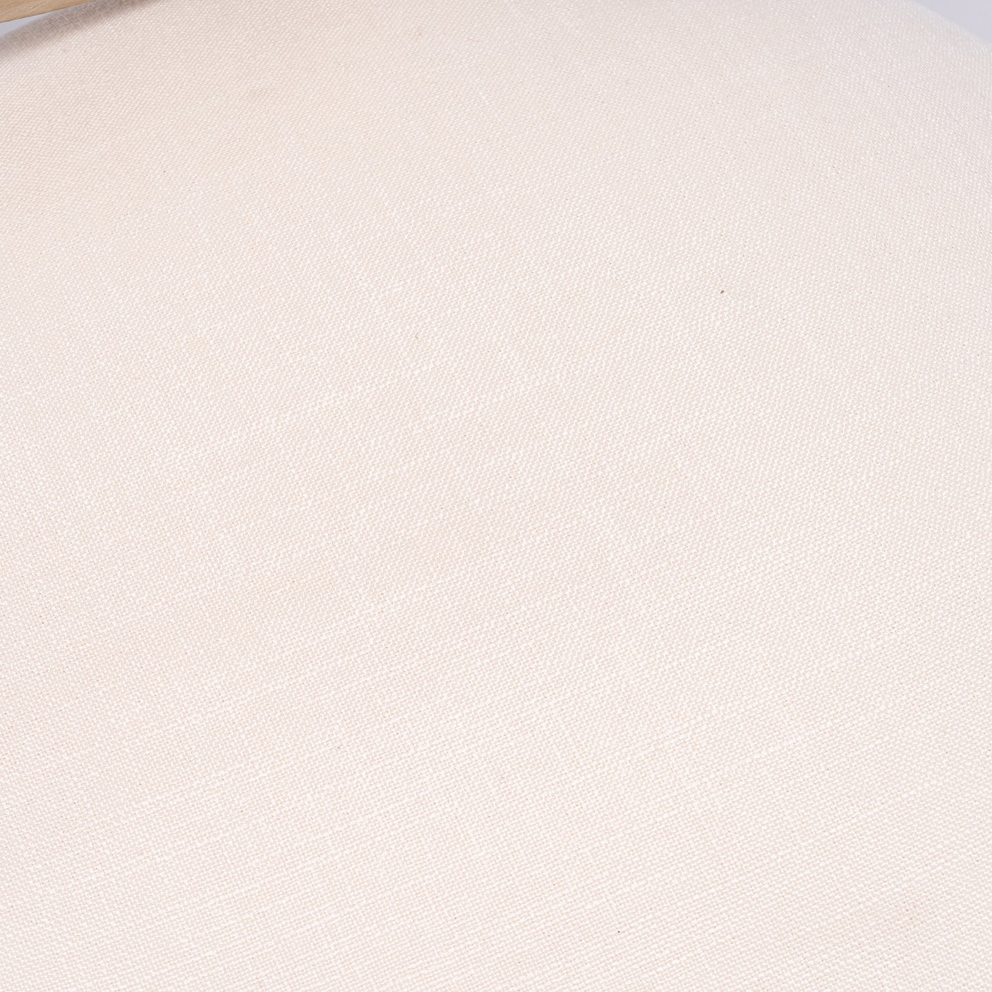 Closeup of a textured cream linen fabric with a visible weave