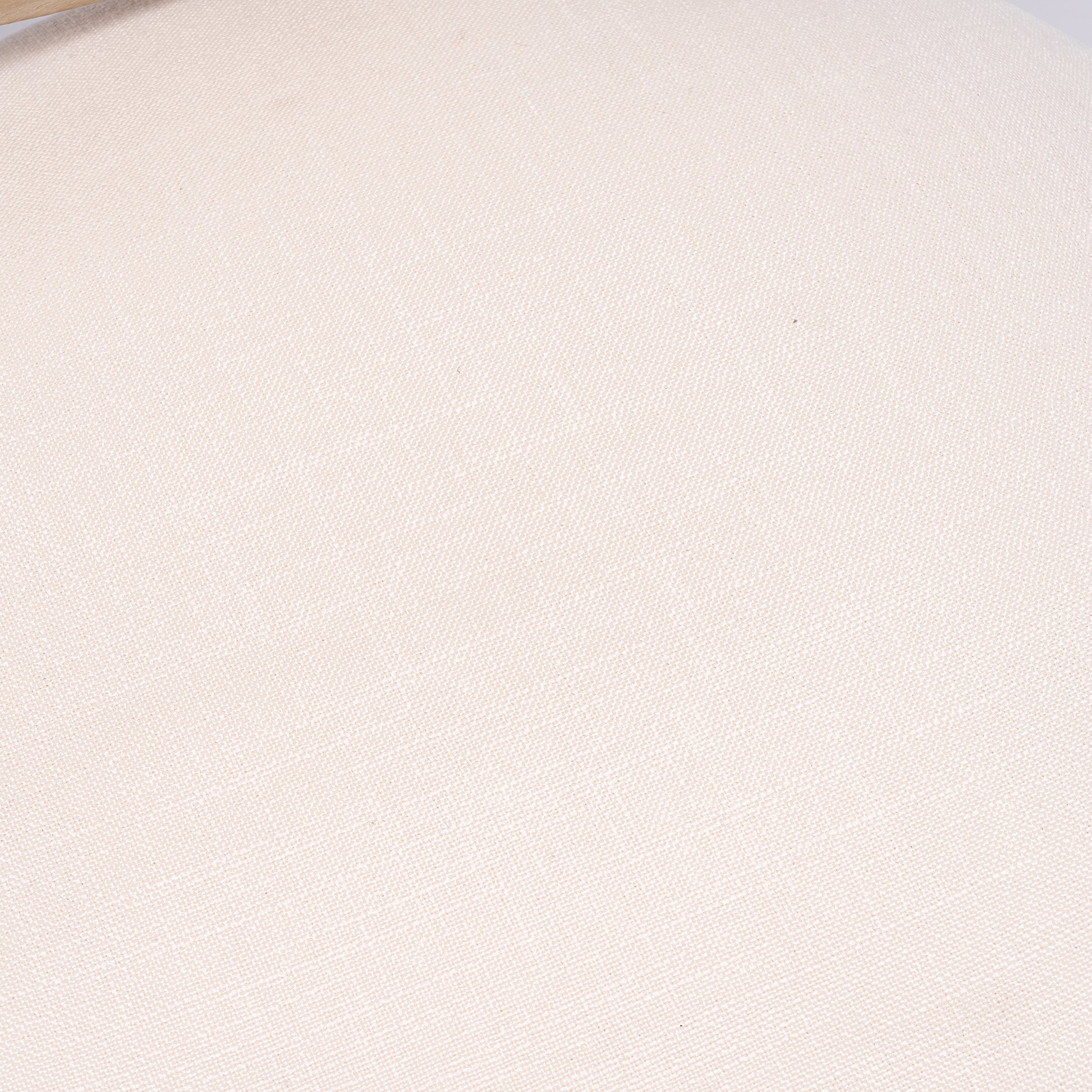 Closeup of a textured cream linen fabric with a visible weave