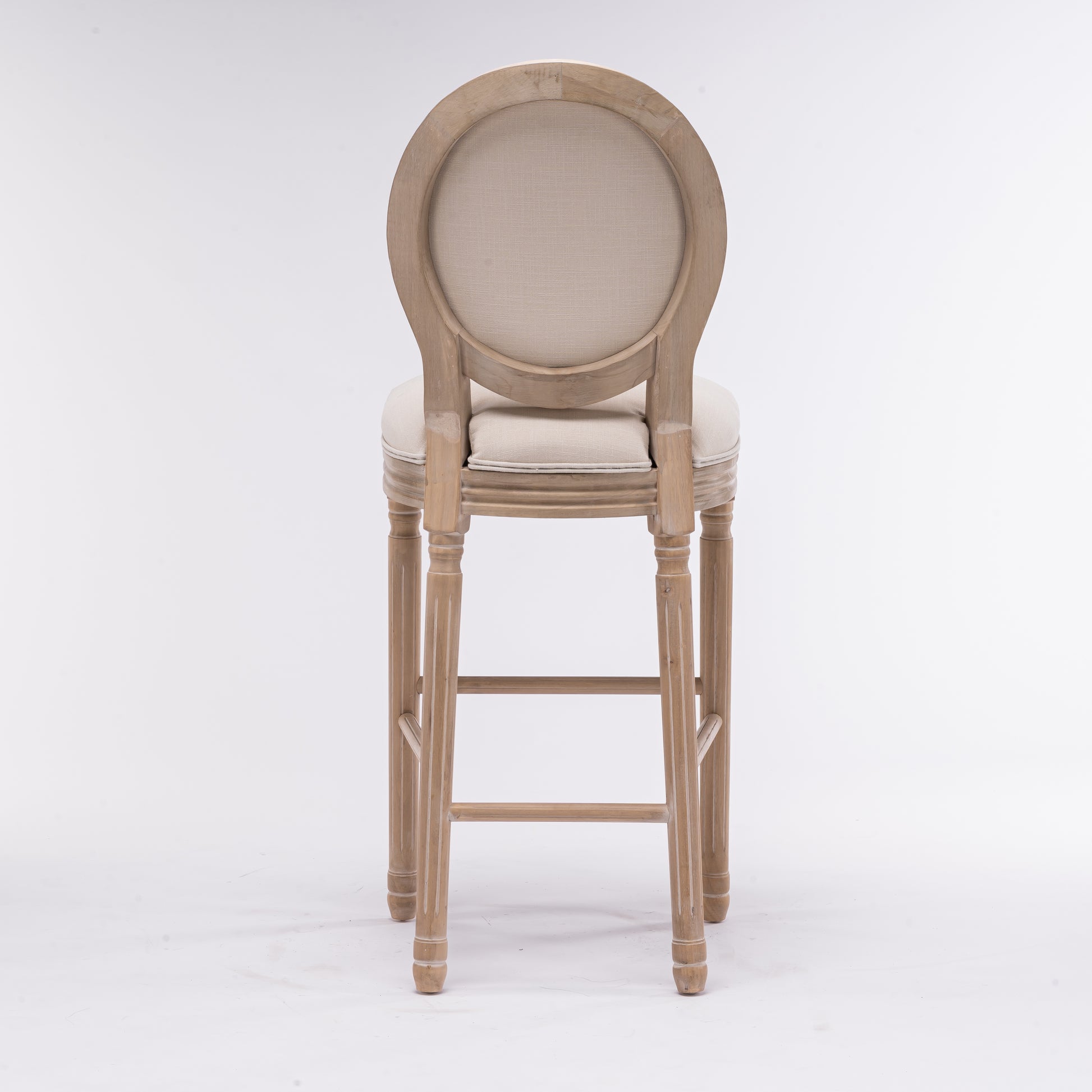 Back view of light wood oval back bar stool with beige upholstered seat and back