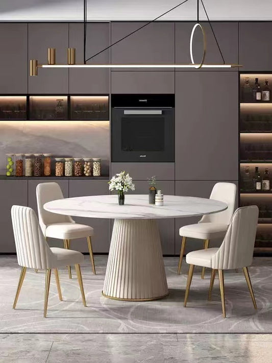 Modern marble dining table with fluted pedestal base and velvet dining chairs