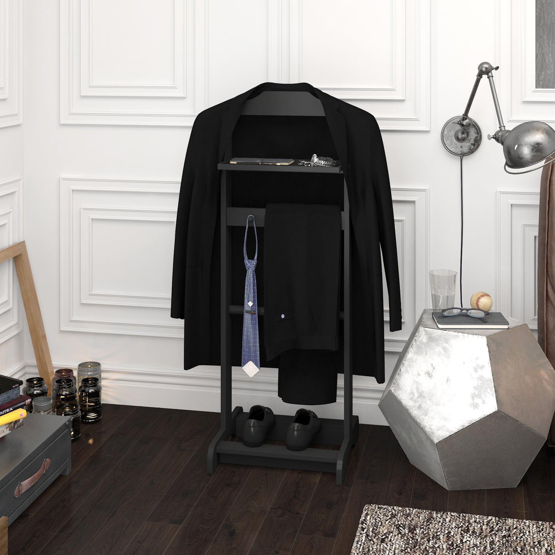 Black suit jacket draped over a valet stand with tie and pants