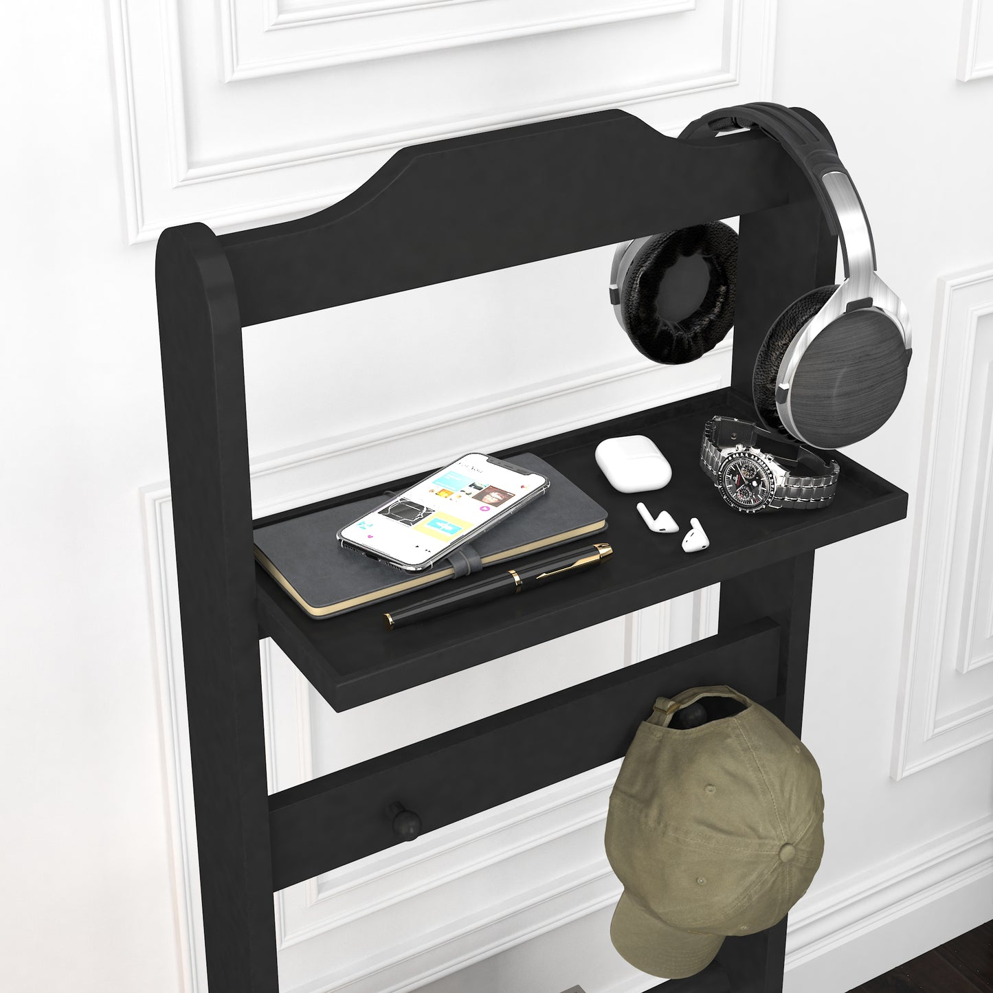 Black headphone stand with overear headphones and shelf for tech accessories