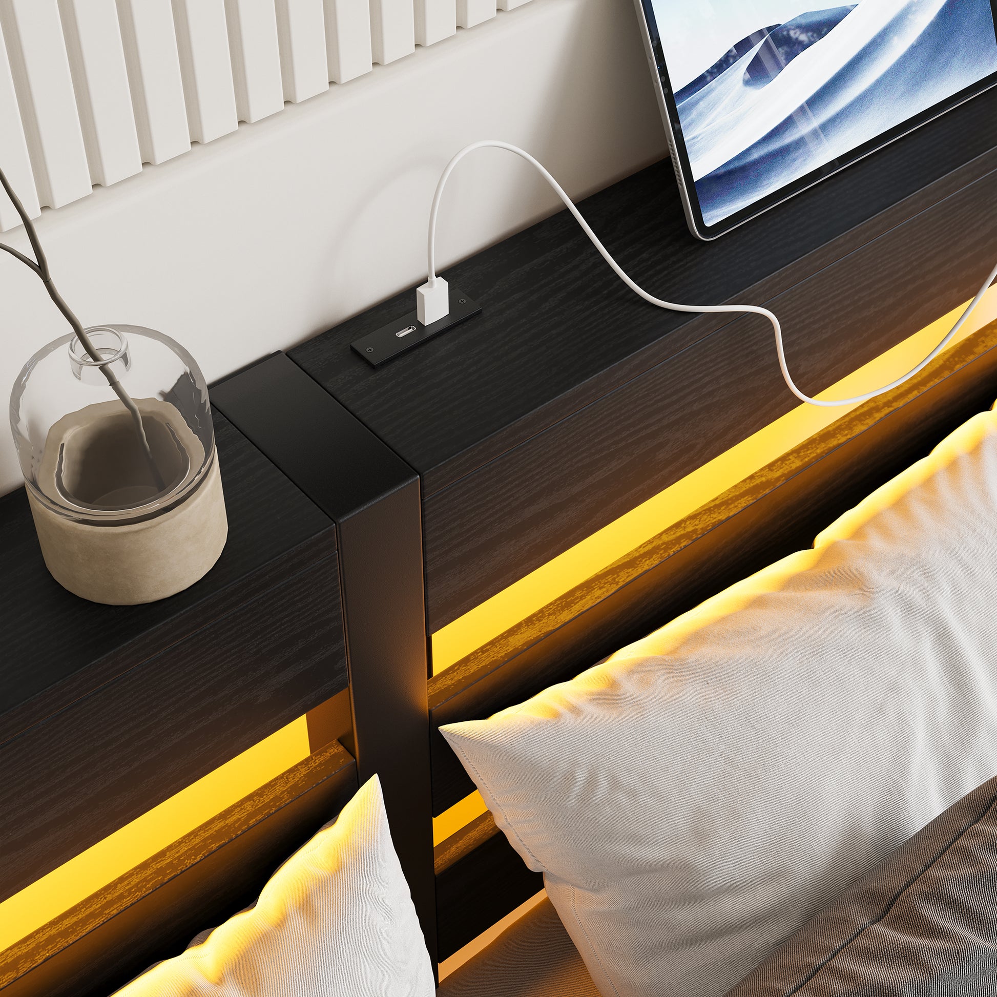 Modern black wood nightstand with builtin USB charging ports and warm ambient LED lighting