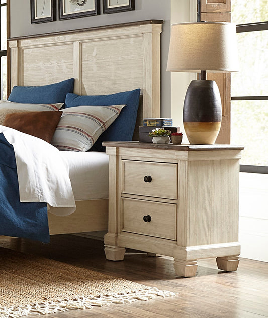 Distressed white wood nightstand with two drawers and dark knobs part of a bedroom set