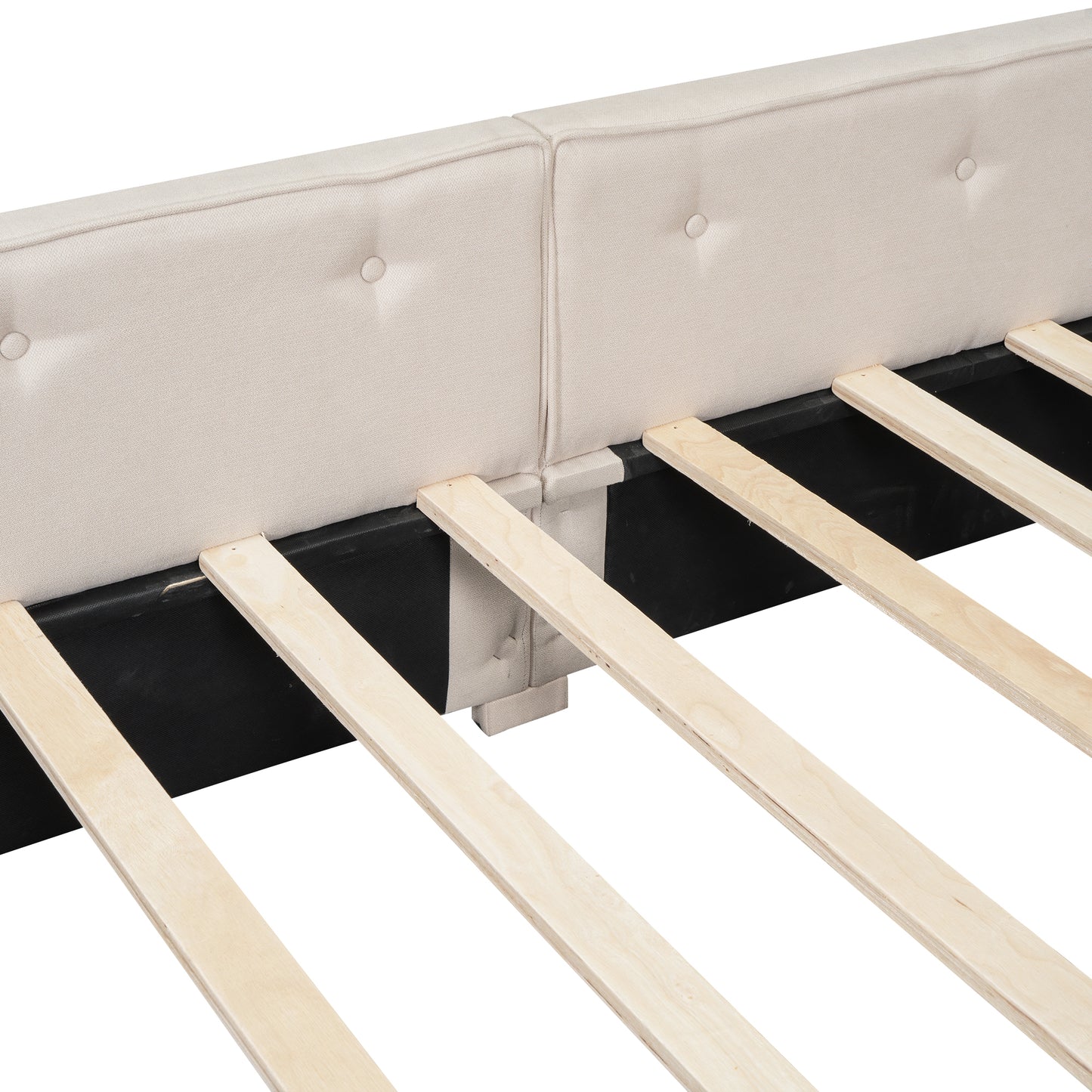 Tufted beige upholstered headboard detail on a modern bed frame