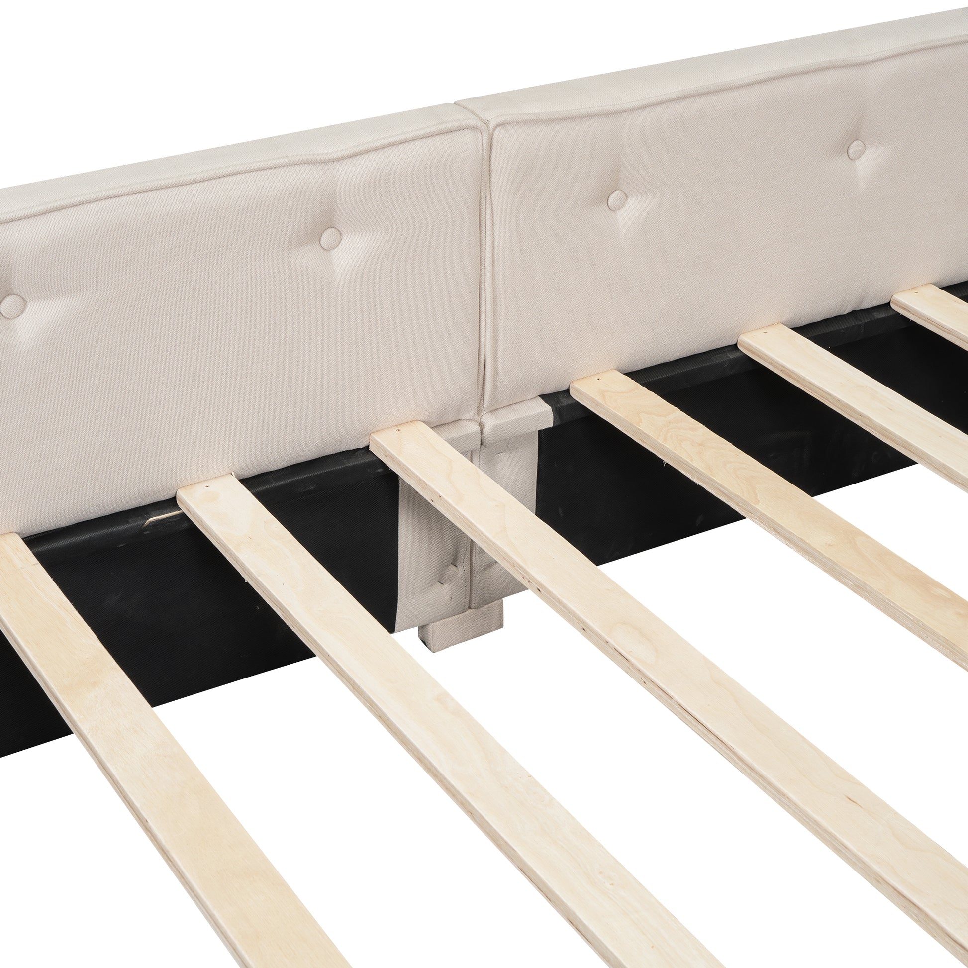 Tufted beige upholstered headboard detail on a modern bed frame