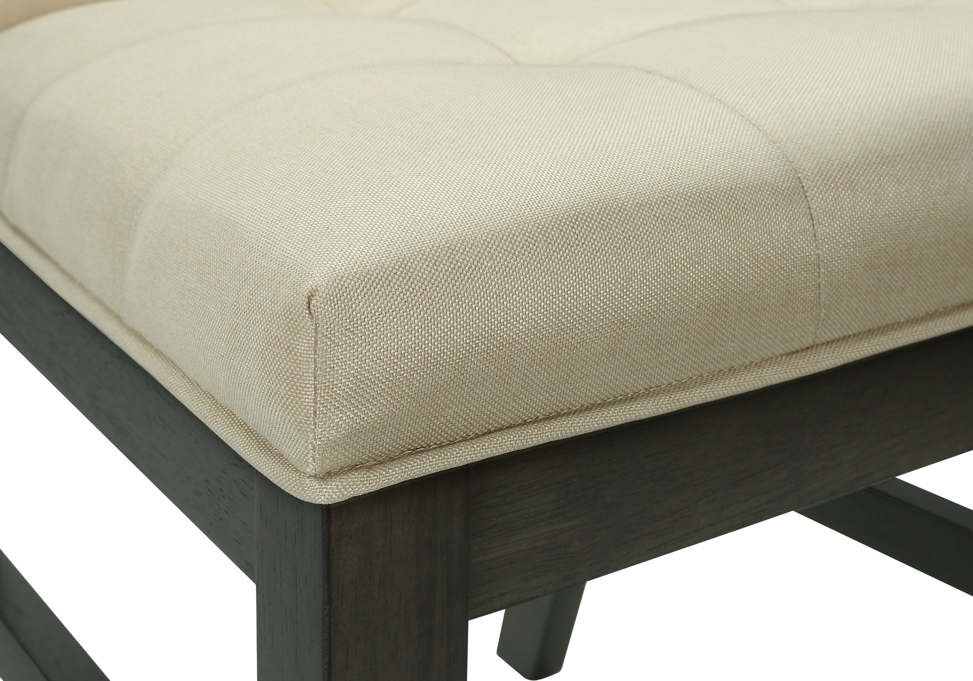 Tufted beige fabric ottoman with dark wood base