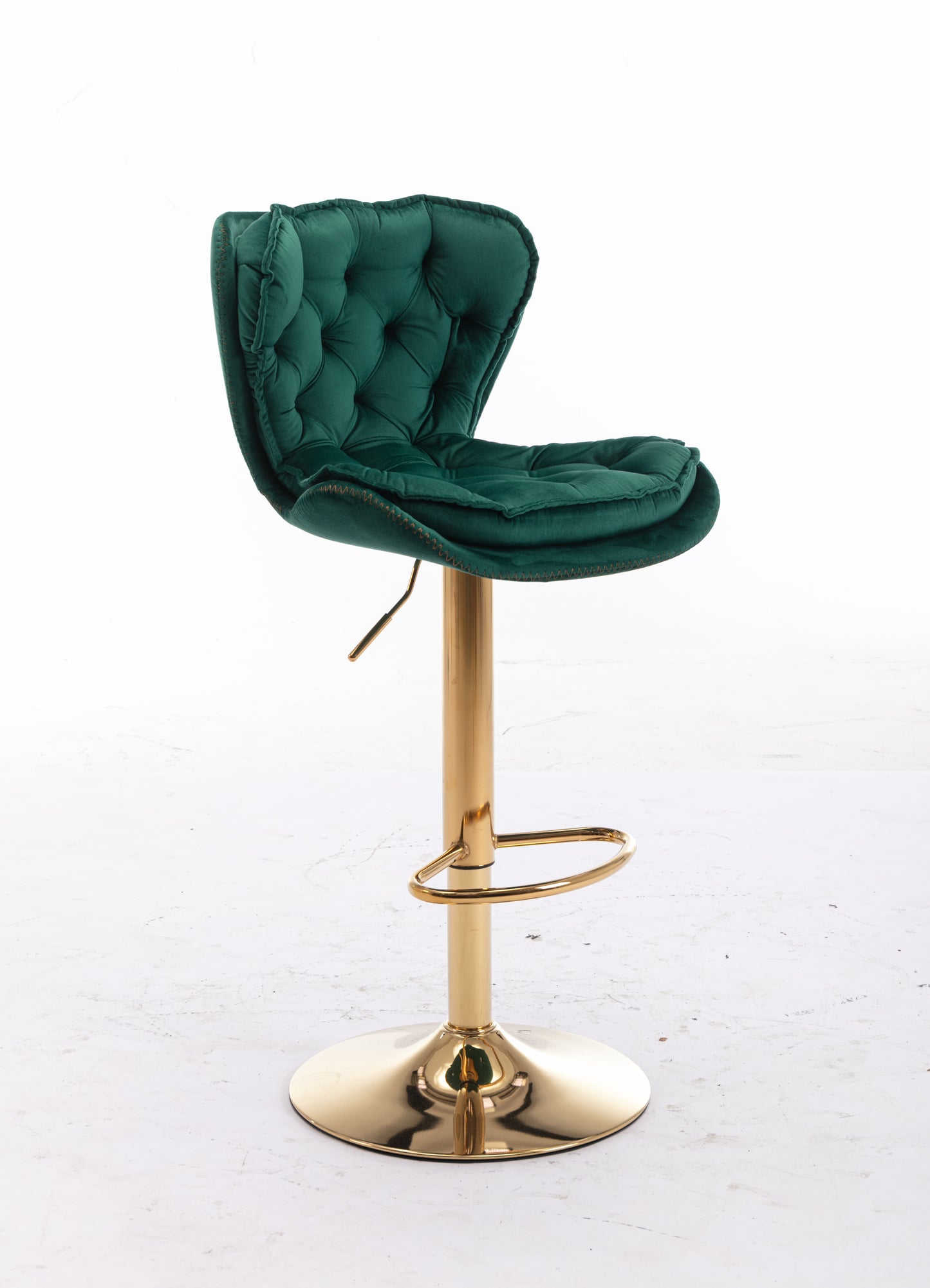 Emerald green velvet tufted bar stool with gold base and footrest