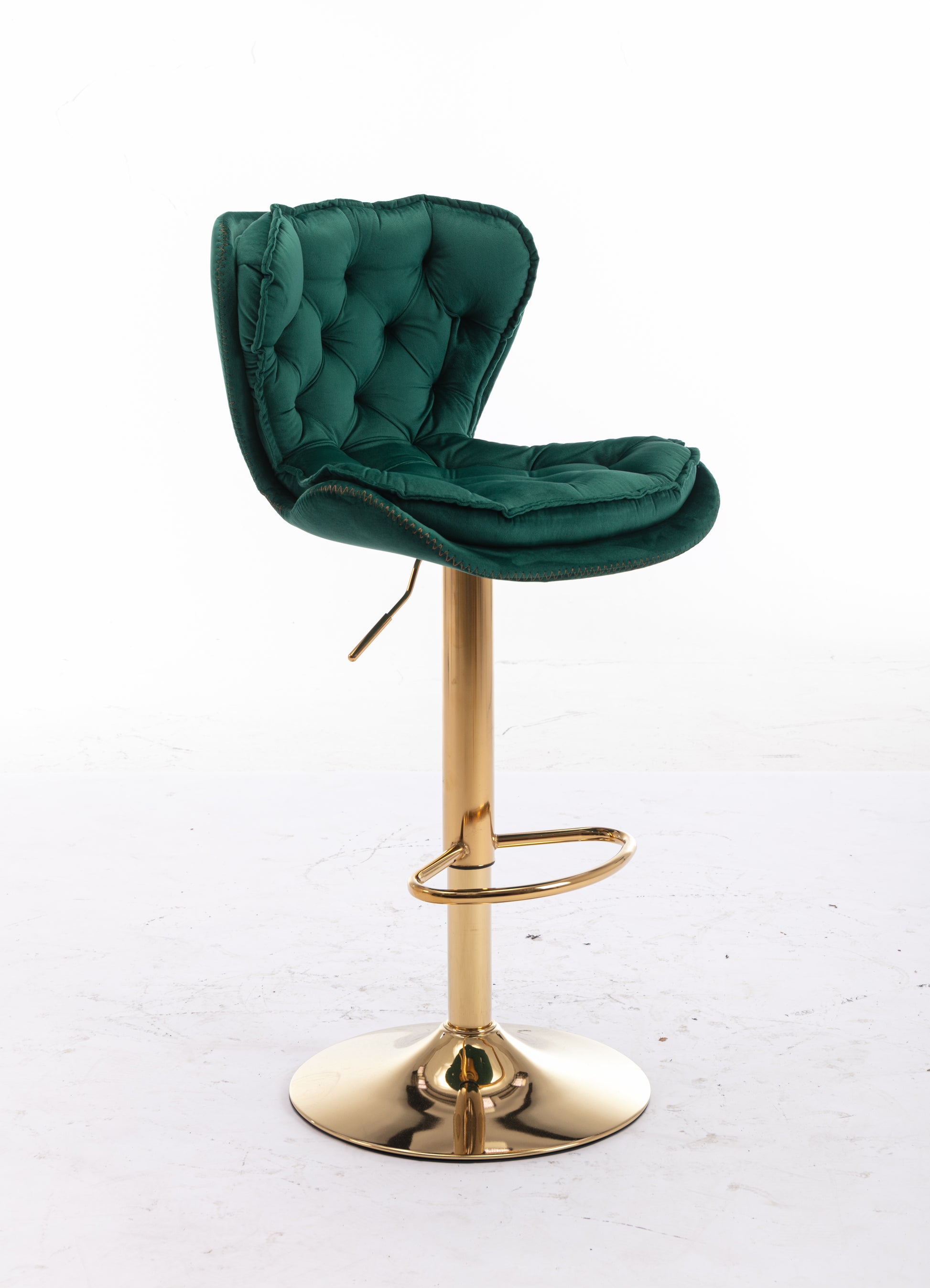Emerald green velvet tufted bar stool with gold base and footrest