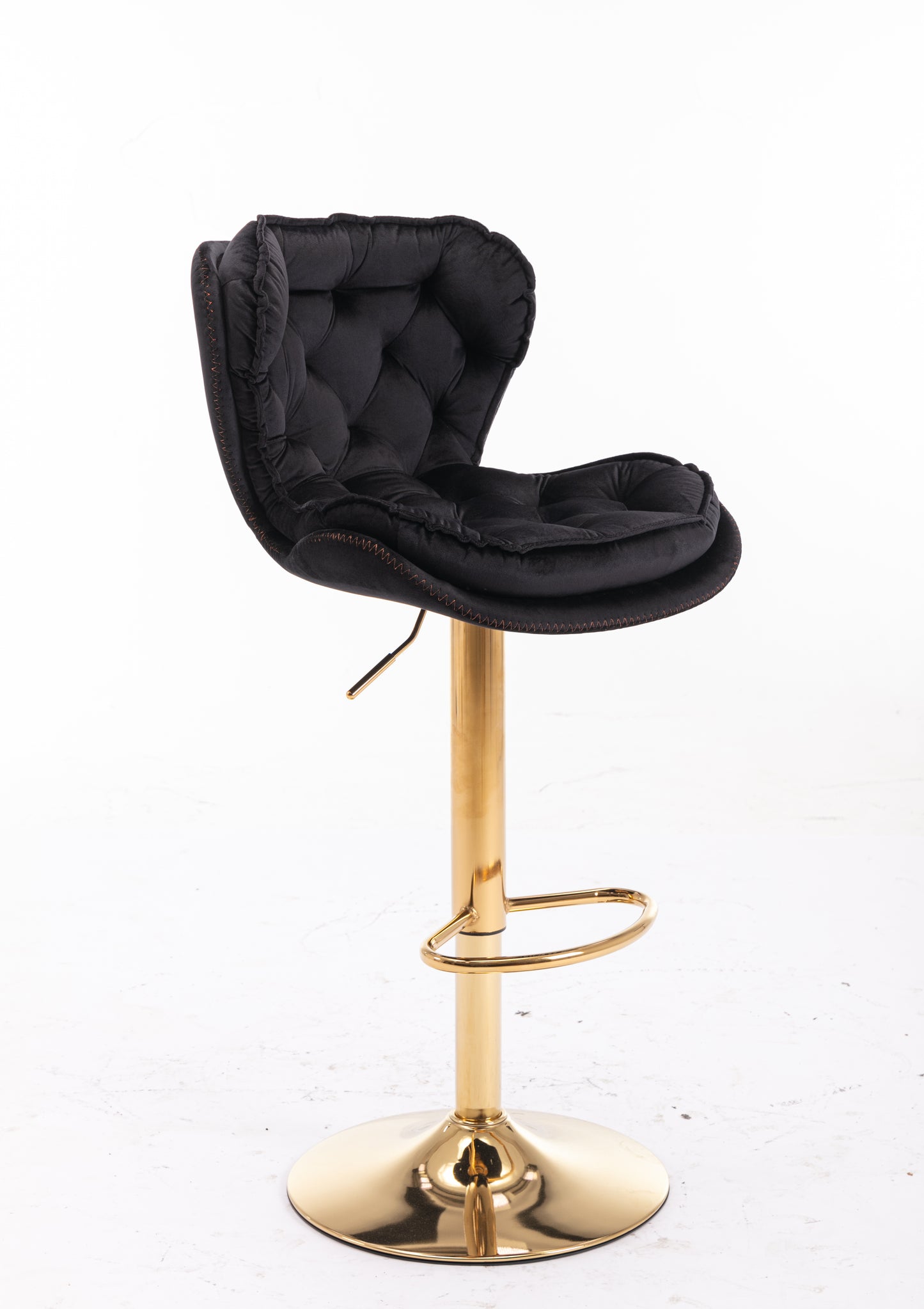 Black velvet bar stool with tufted back and gold base