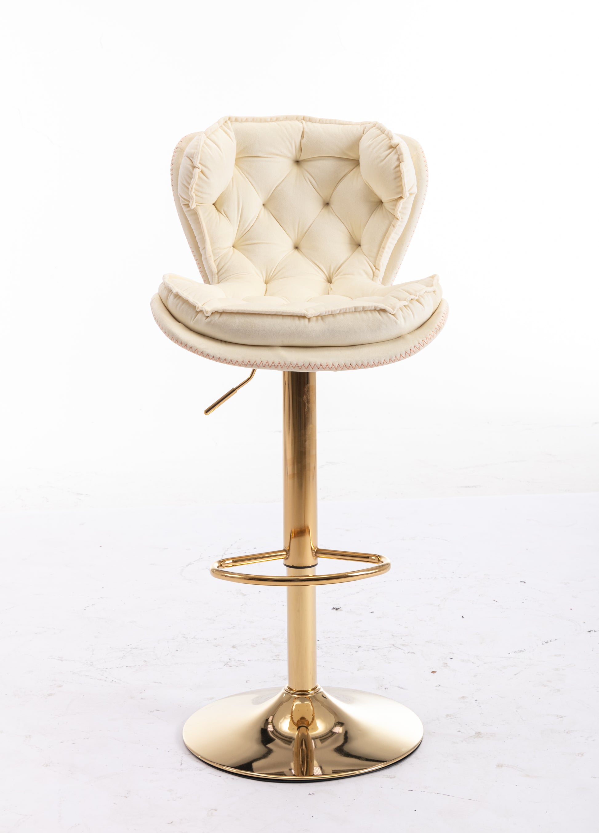 Tufted cream velvet bar stool with gold pedestal base and footrest