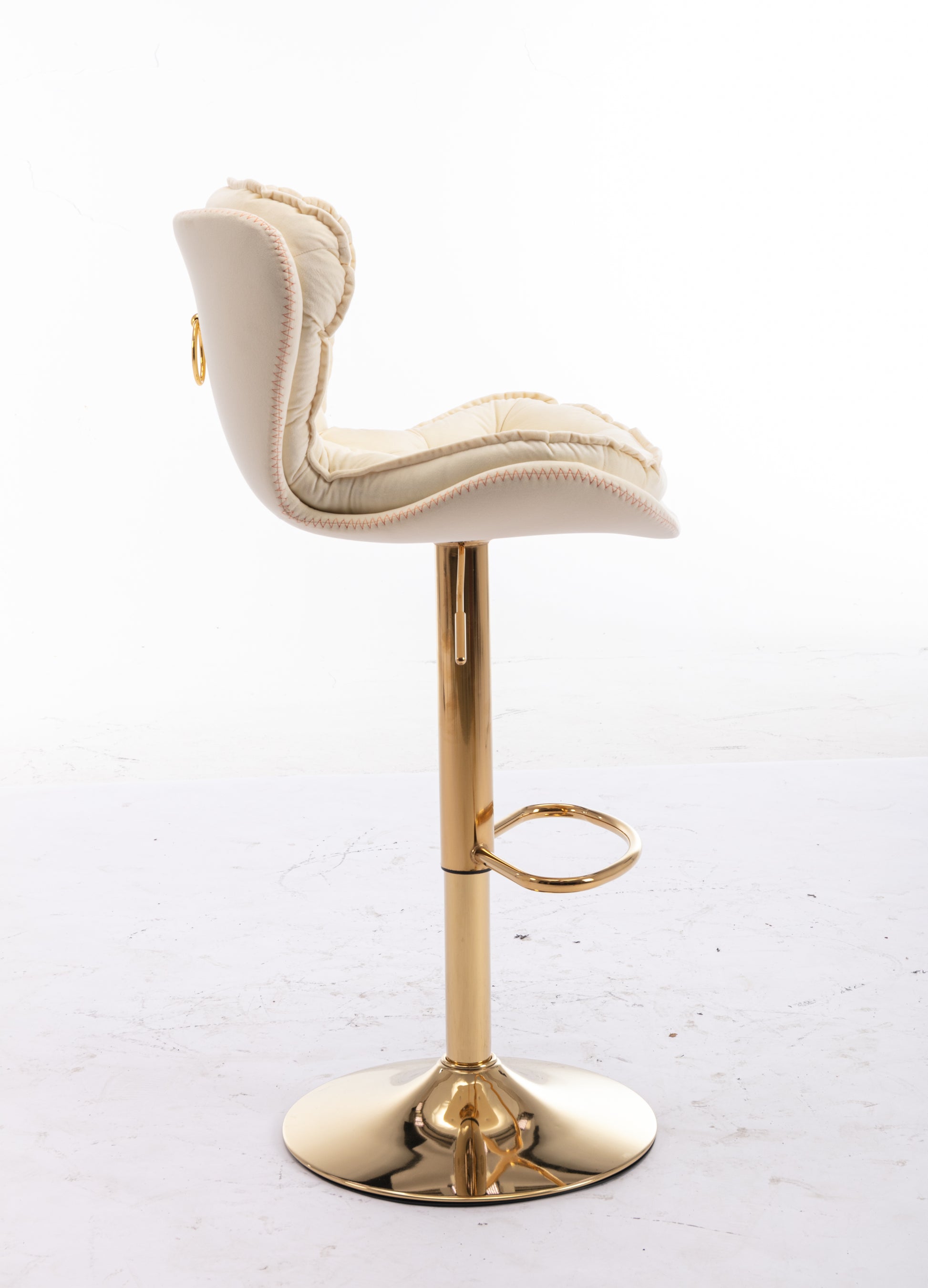 Cream upholstered bar stool with tufted detail and gold base