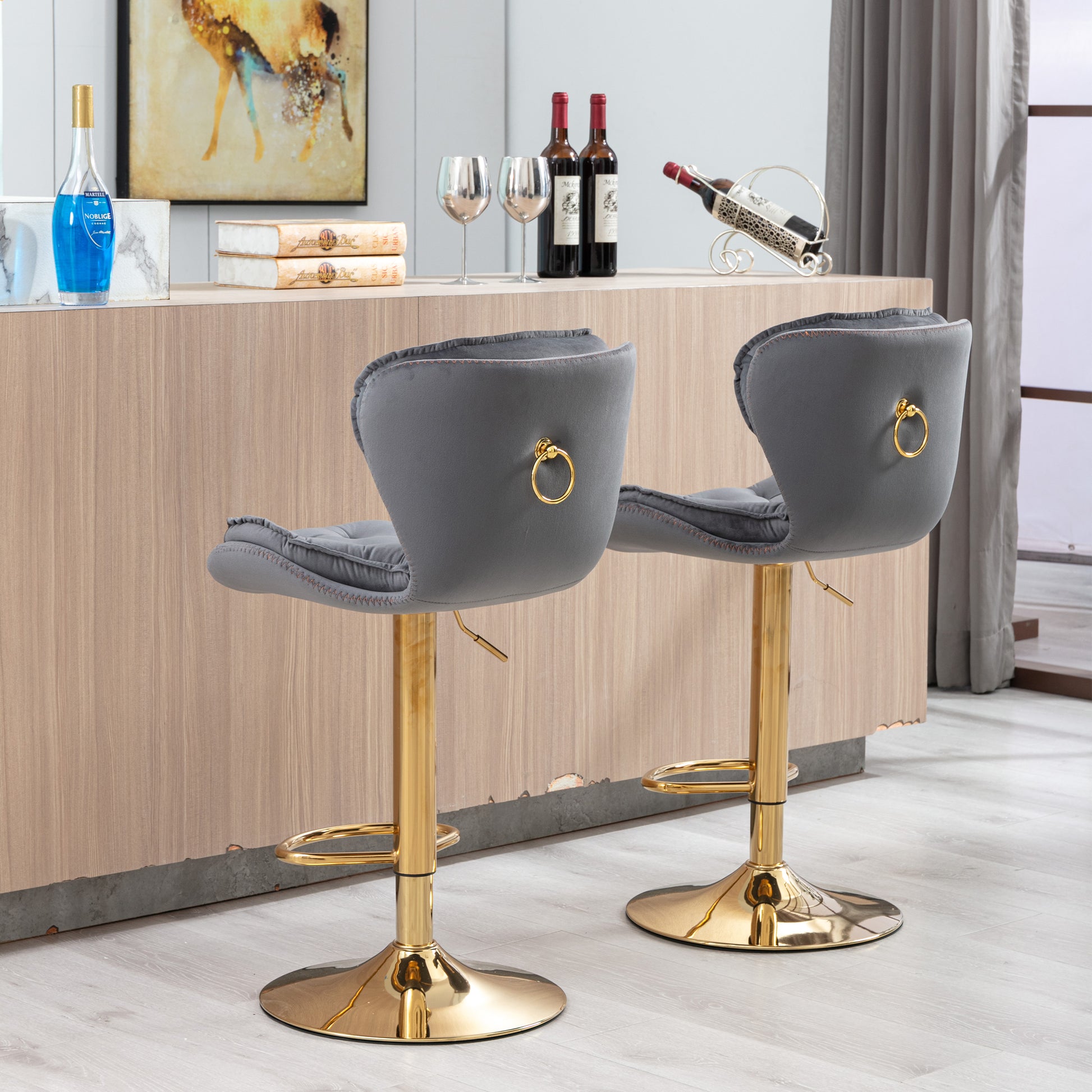 Pair of gray velvet bar stools with gold ring accent and gold adjustable base