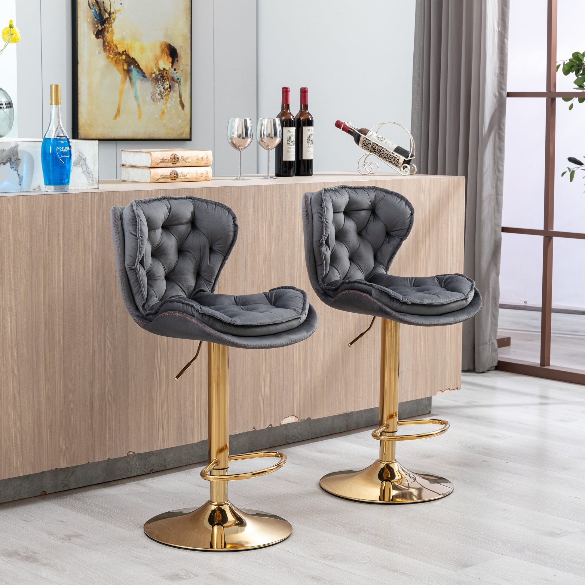 Gray velvet tufted bar stool with gold base and adjustable height