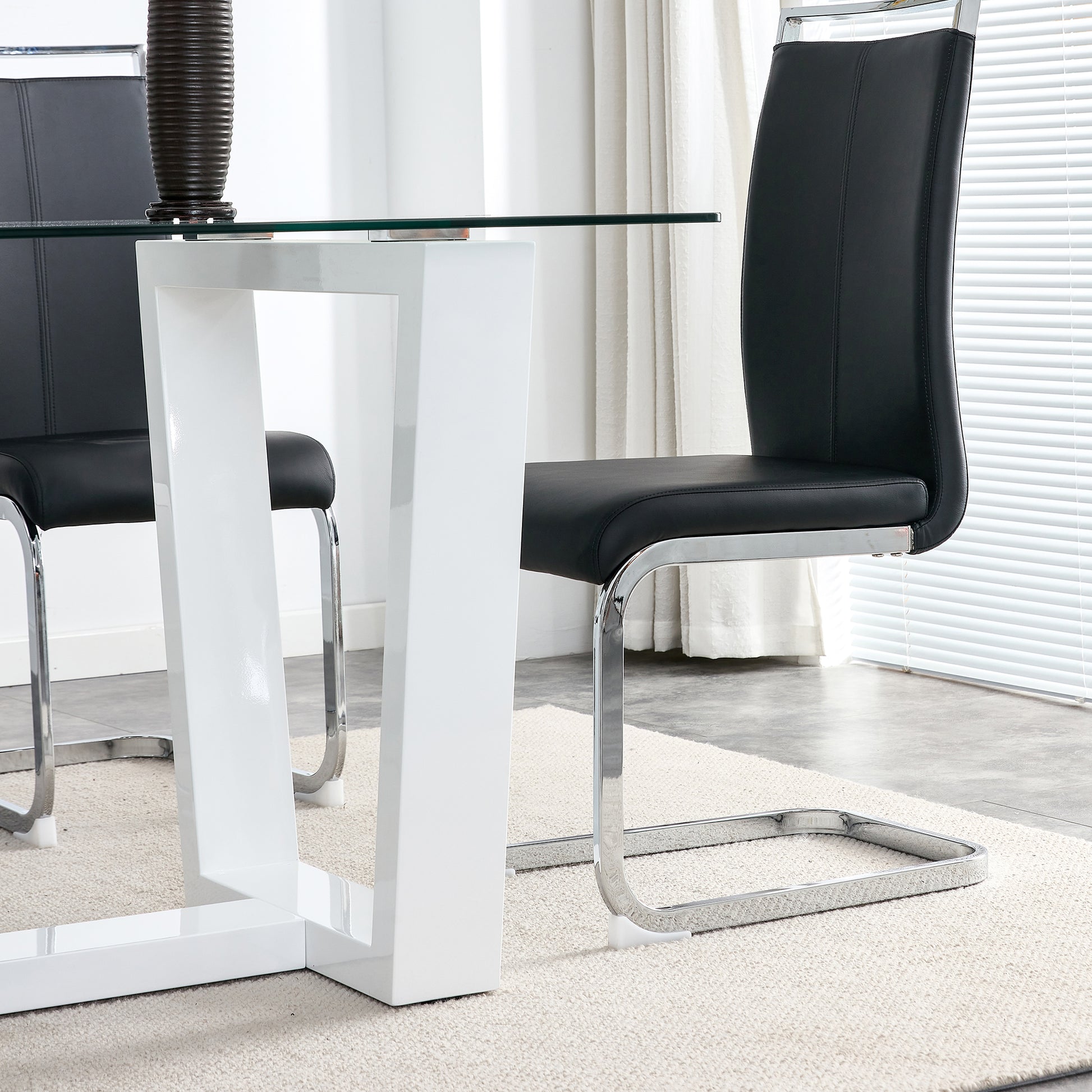Black leather dining chair with chrome legs