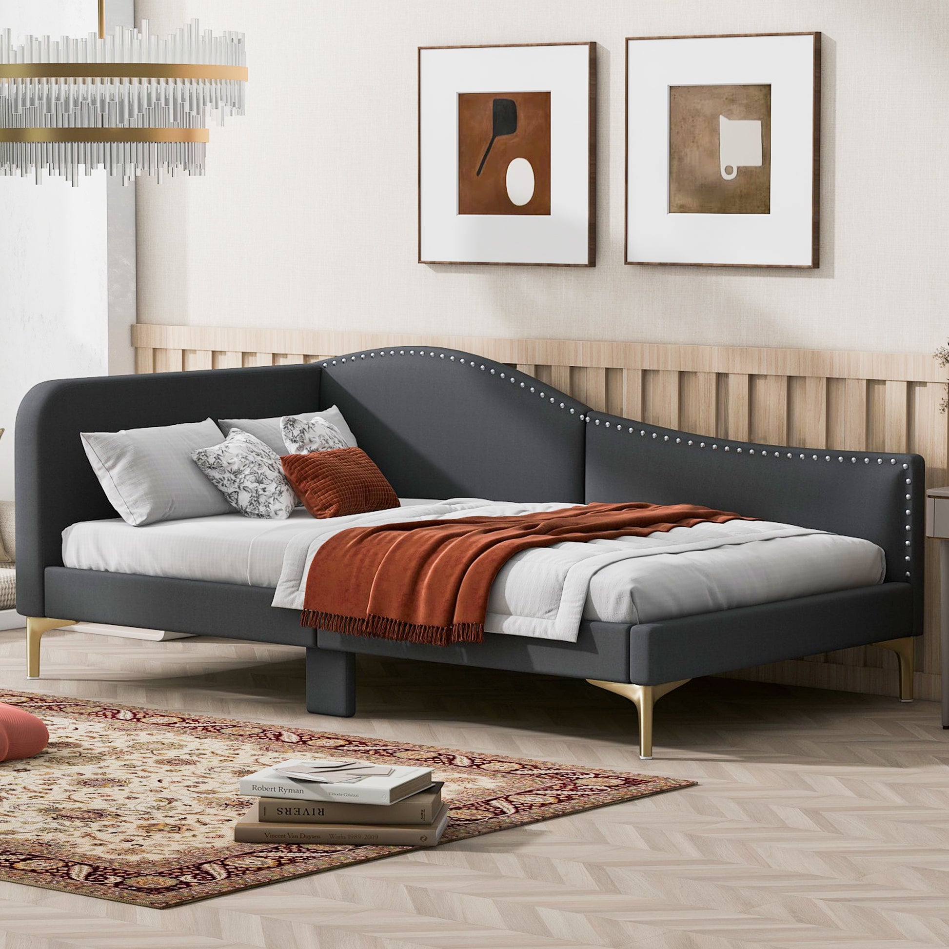 Dark gray velvet daybed with studded trim and gold legs