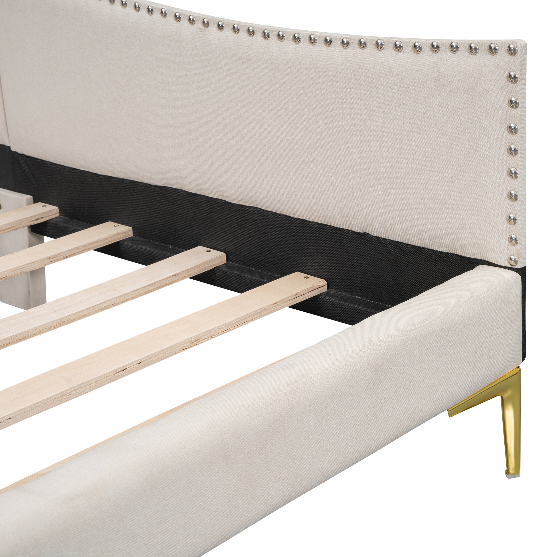 Cream upholstered bed frame with silver nailhead trim and gold legs