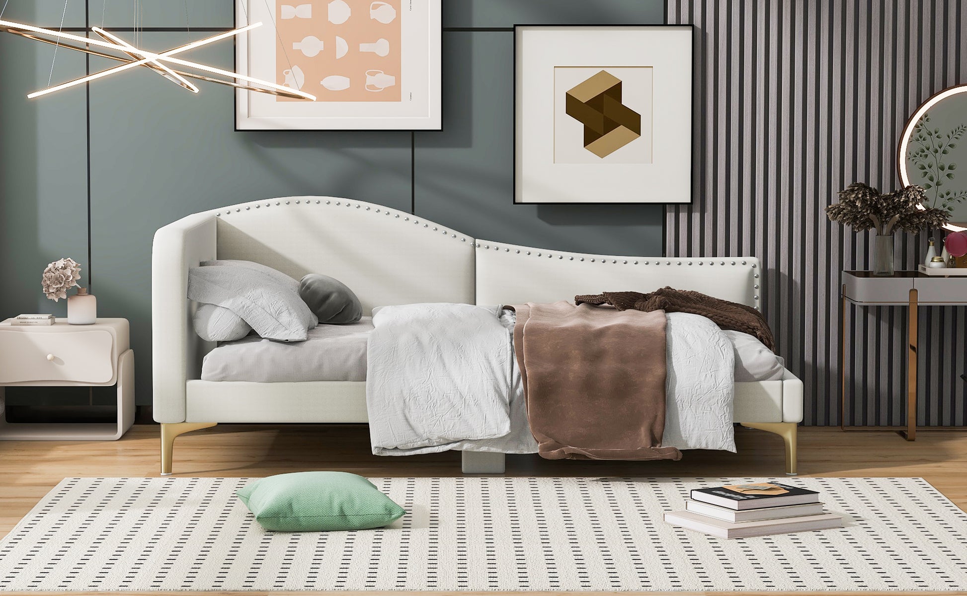 White upholstered daybed with nailhead trim and gold legs