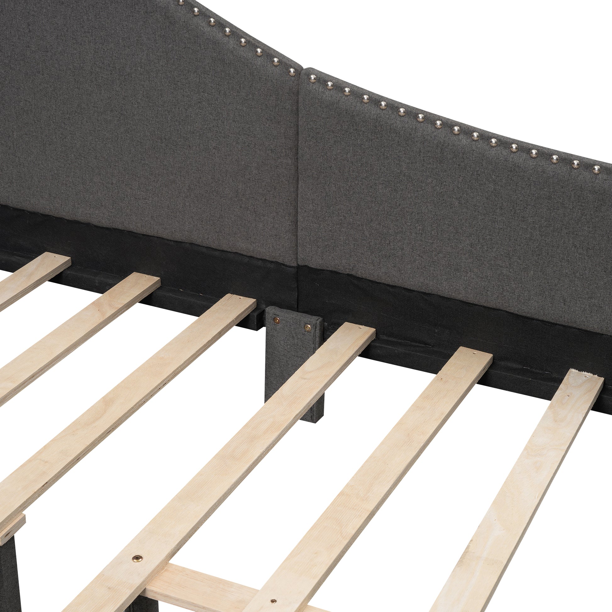 Dark grey fabric headboard with silver nailhead trim and wooden slats