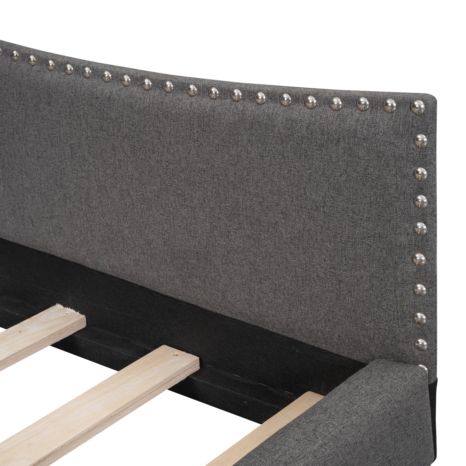 Dark grey upholstered headboard with silver nailhead trim detail