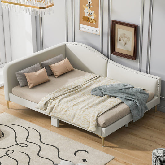 White upholstered daybed with curved back and gold legs