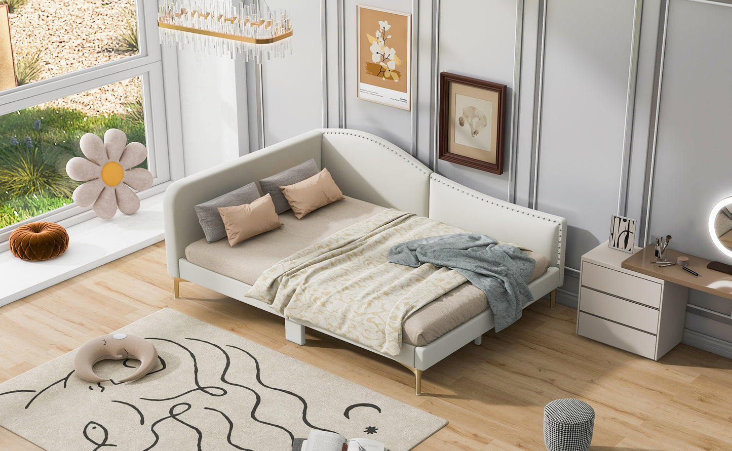 White upholstered tufted sofa bed with gold legs and decorative pillows