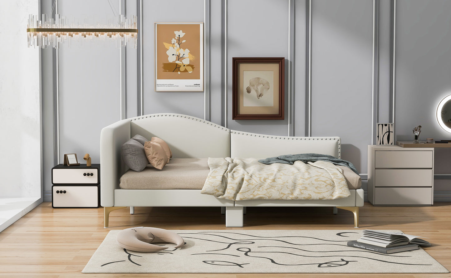 White upholstered daybed with gold legs and studded headboard