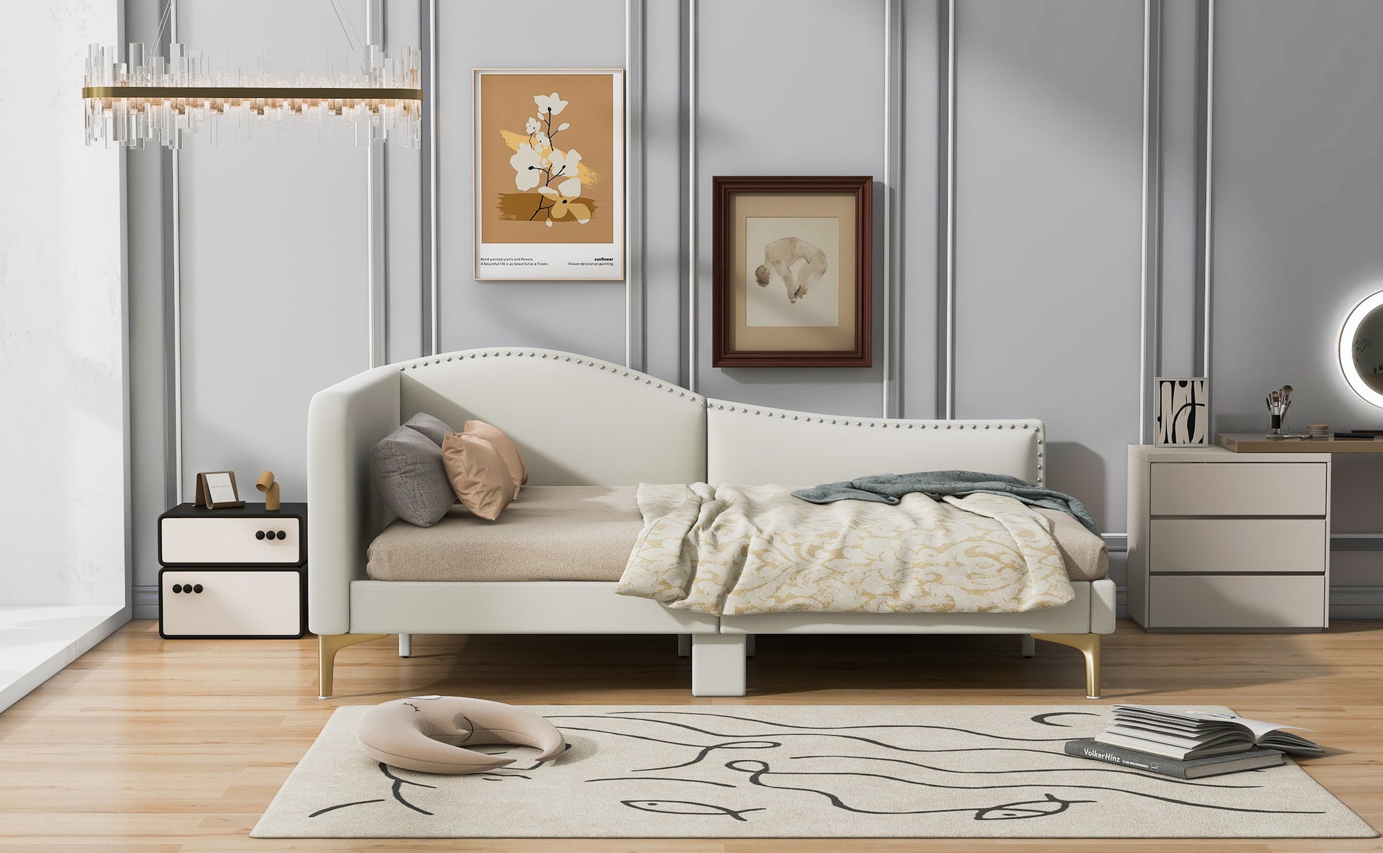 White upholstered daybed with gold legs and studded headboard