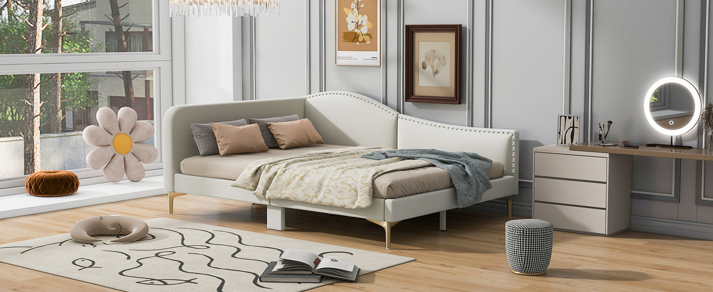 Elegant white daybed with gold legs and studded headboard