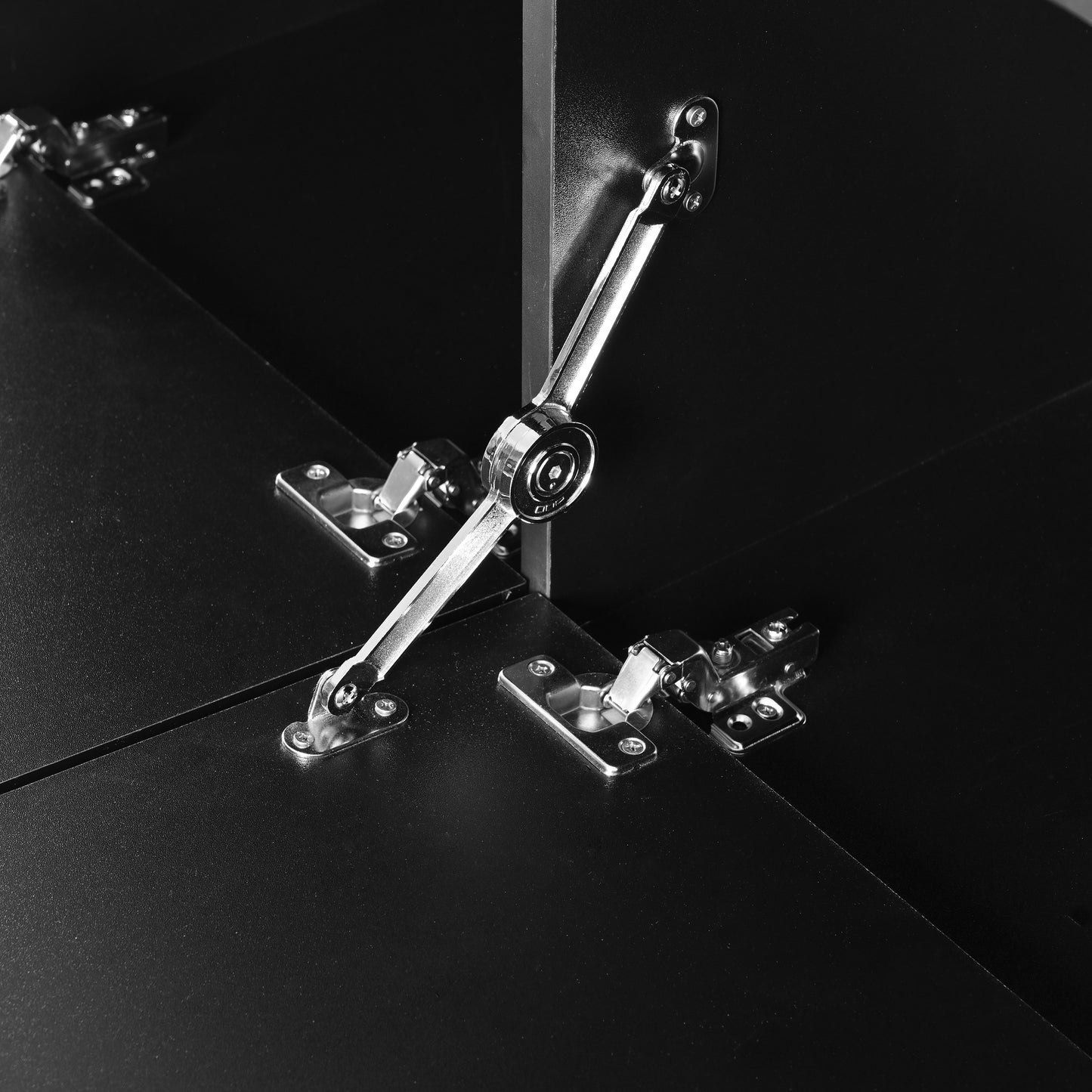 Black cabinet hinge with silver metal arm supporting a door