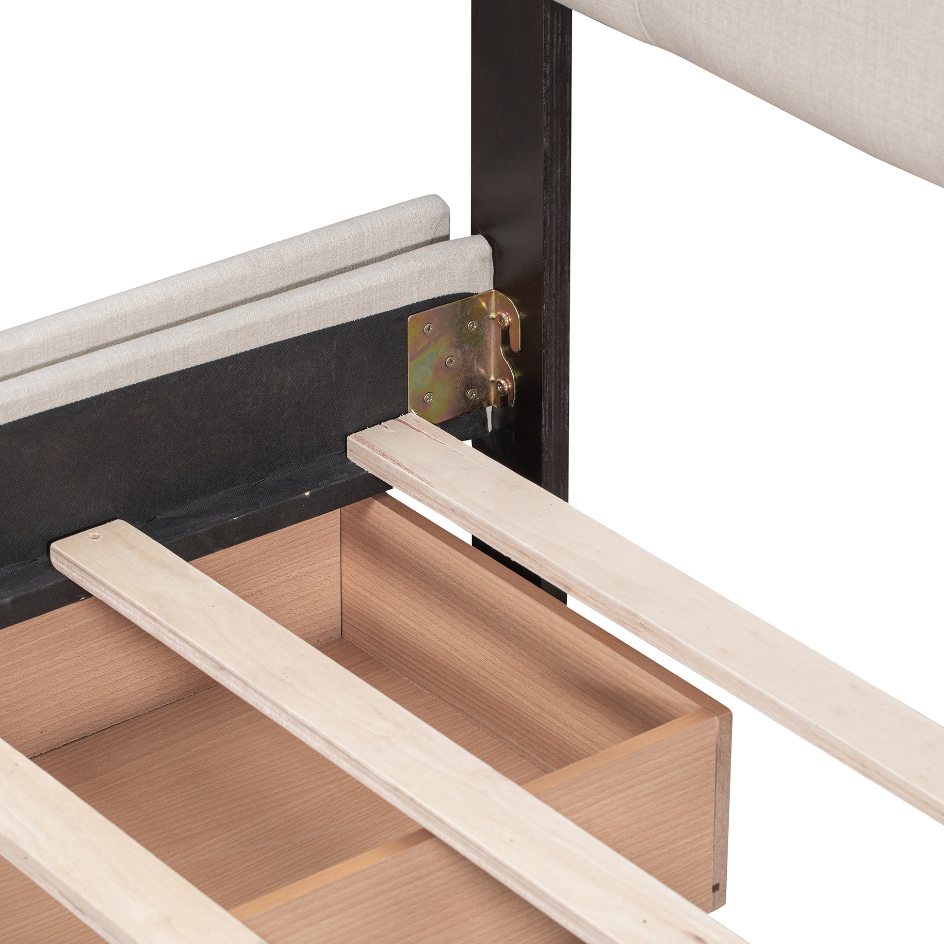 Closeup of upholstered bed frame with visible wood slats and drawer support