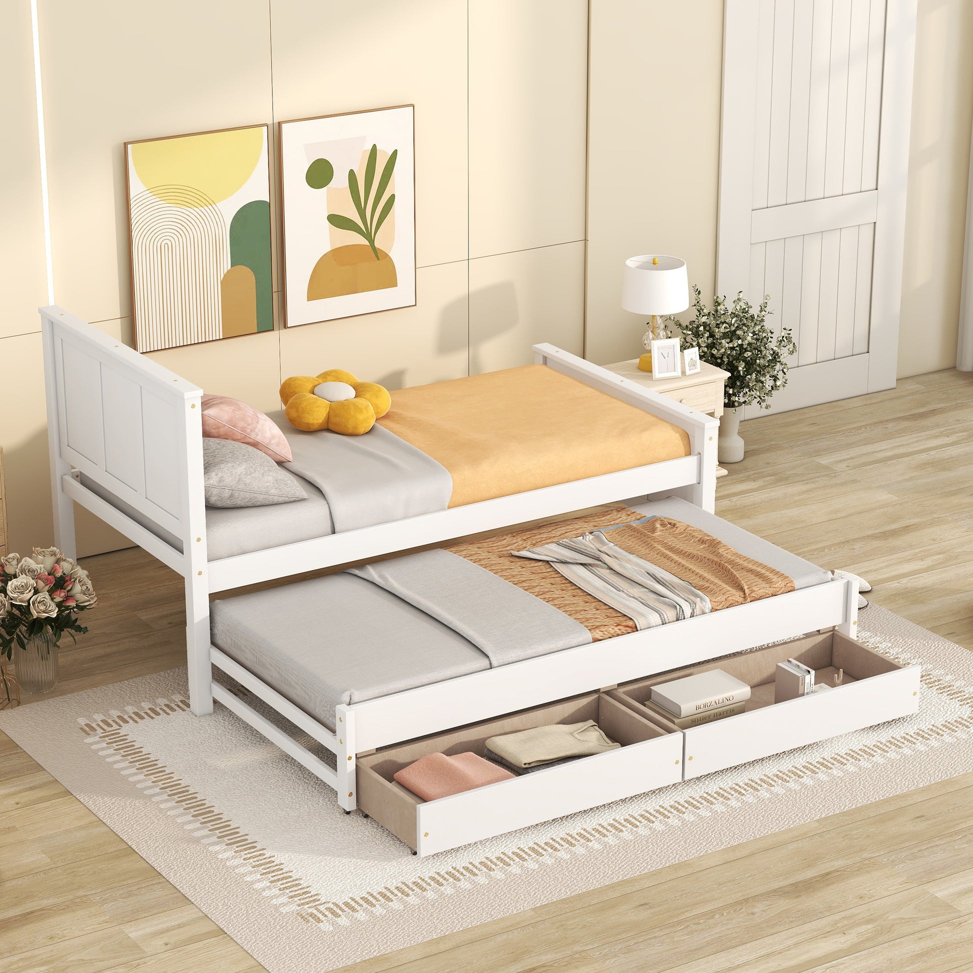 White wooden twin daybed with a pullout trundle and storage drawers