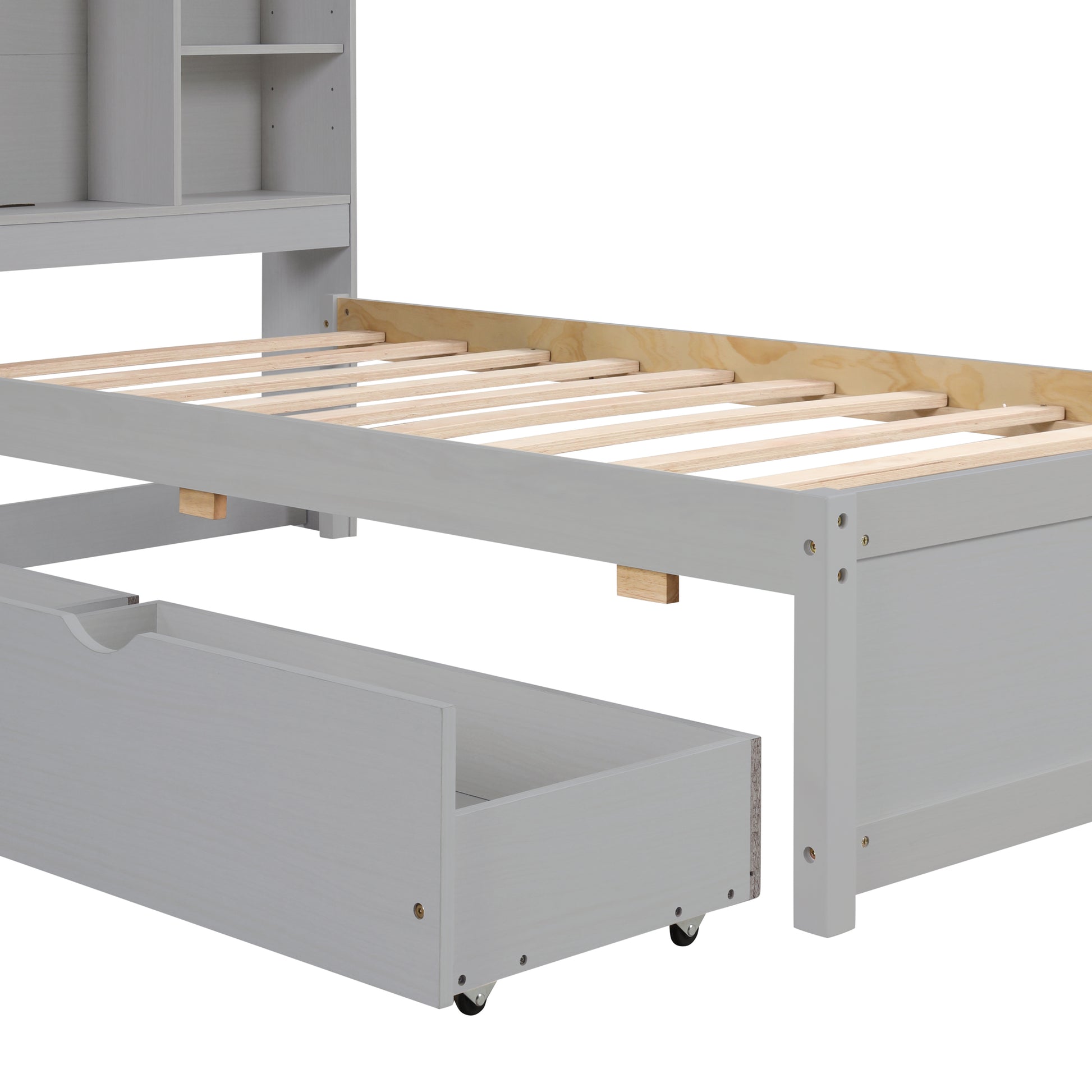 Gray twin bed frame with exposed wooden slats and a rolling storage drawer open