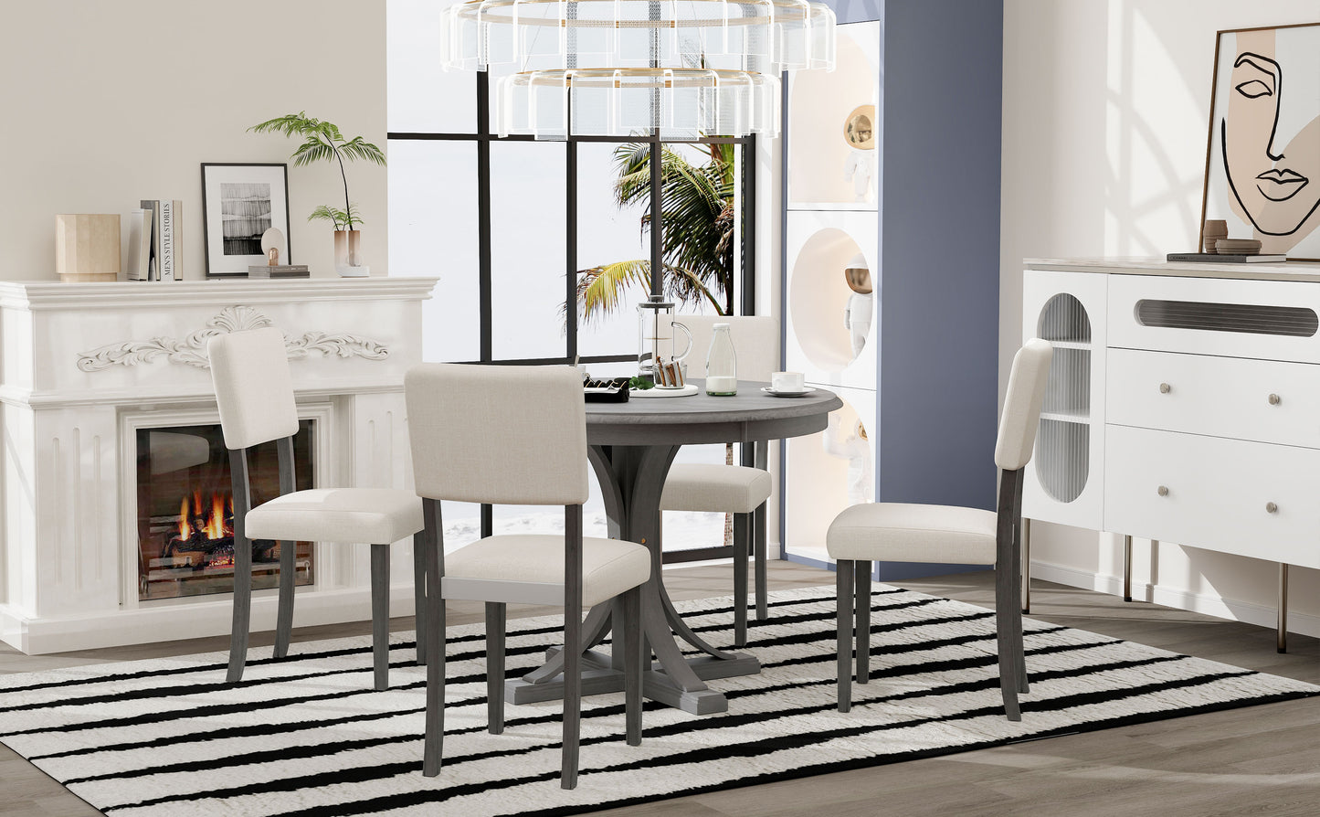 Gray wood pedestal dining table with four upholstered chairs