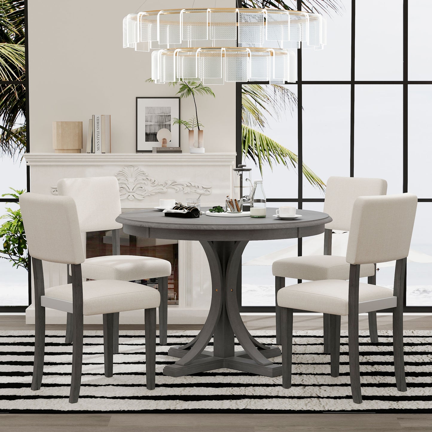 Round gray dining table with four cream upholstered chairs