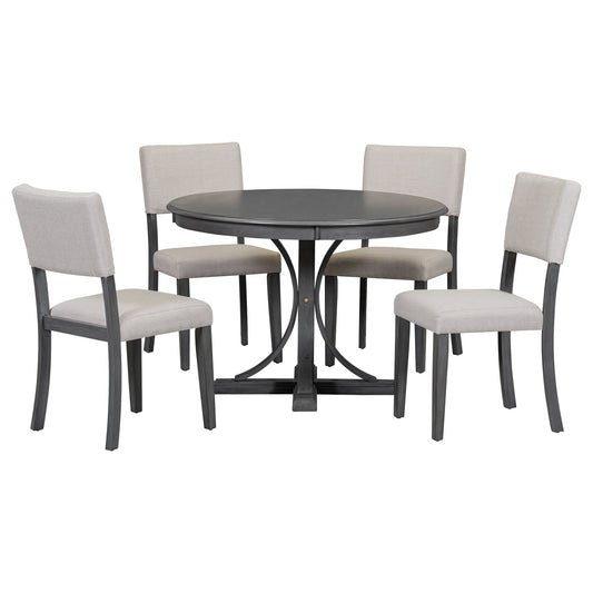 Round dark gray dining table with four upholstered chairs