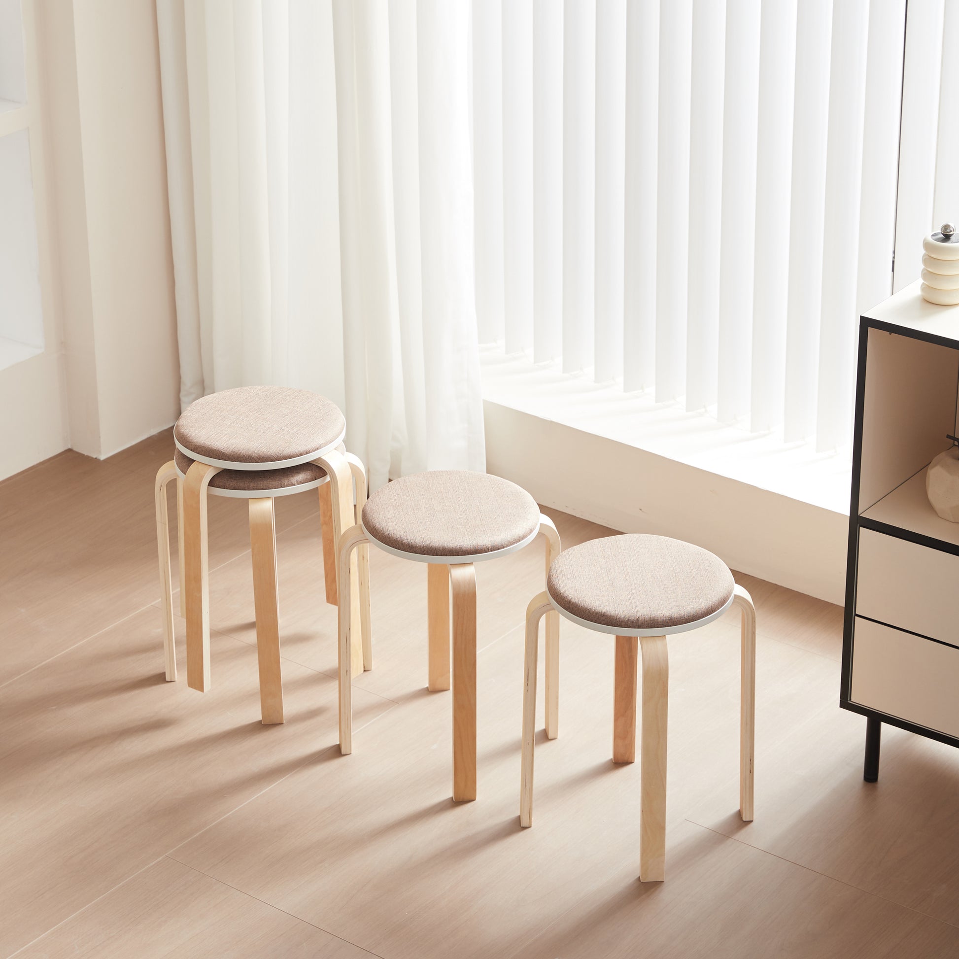 Set of three natural wood stools with beige fabric seats