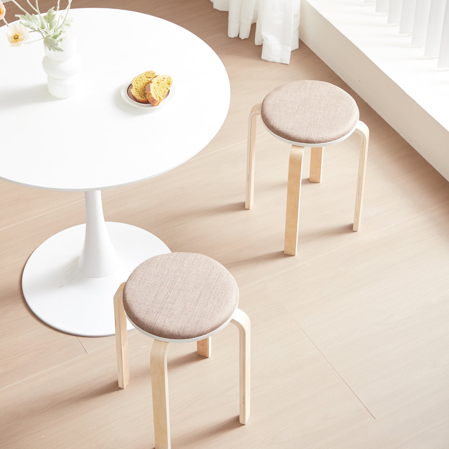 Round fabric stool with light wood legs